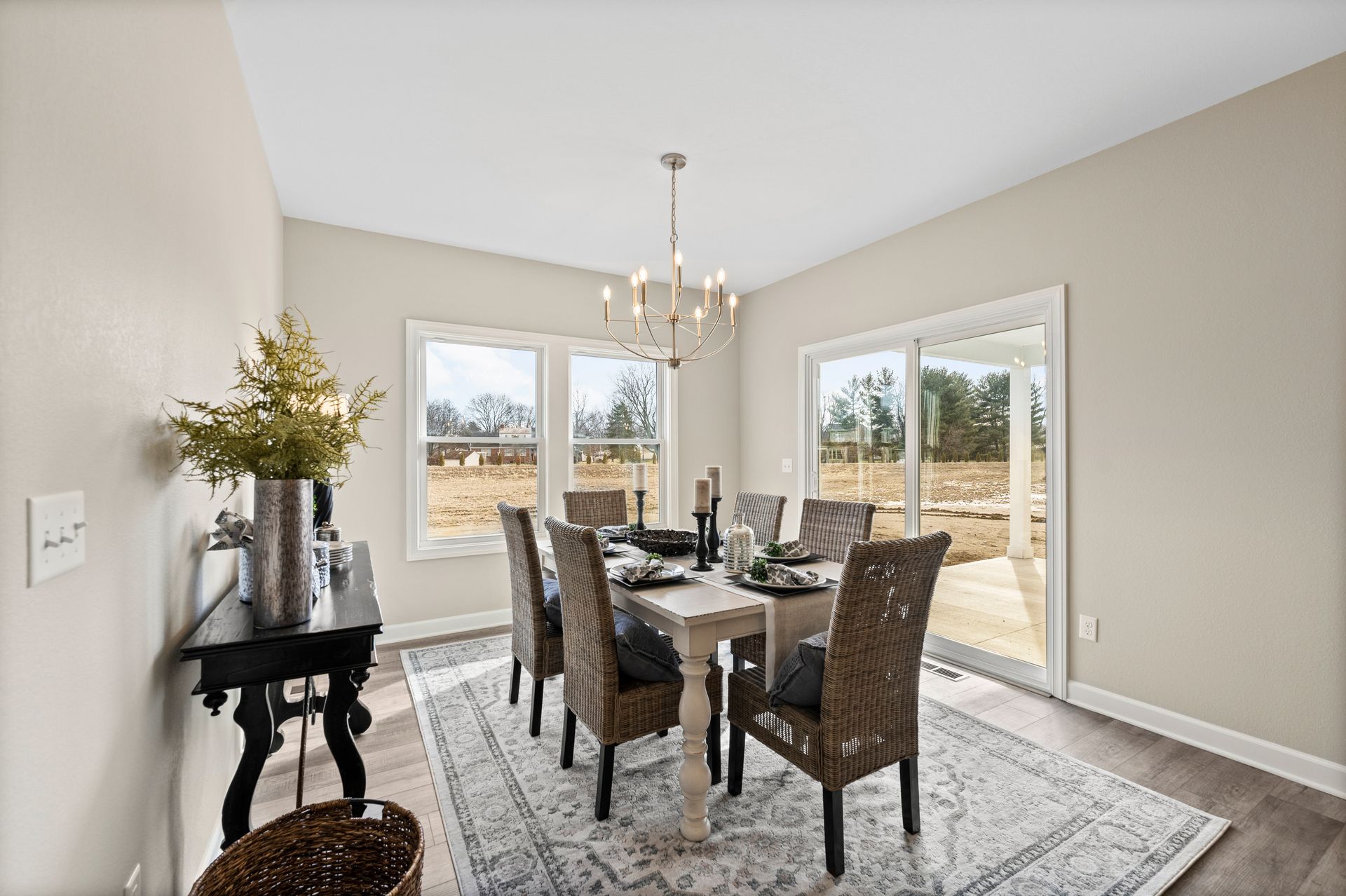 A dining room with a table and chairs and a chandelier.