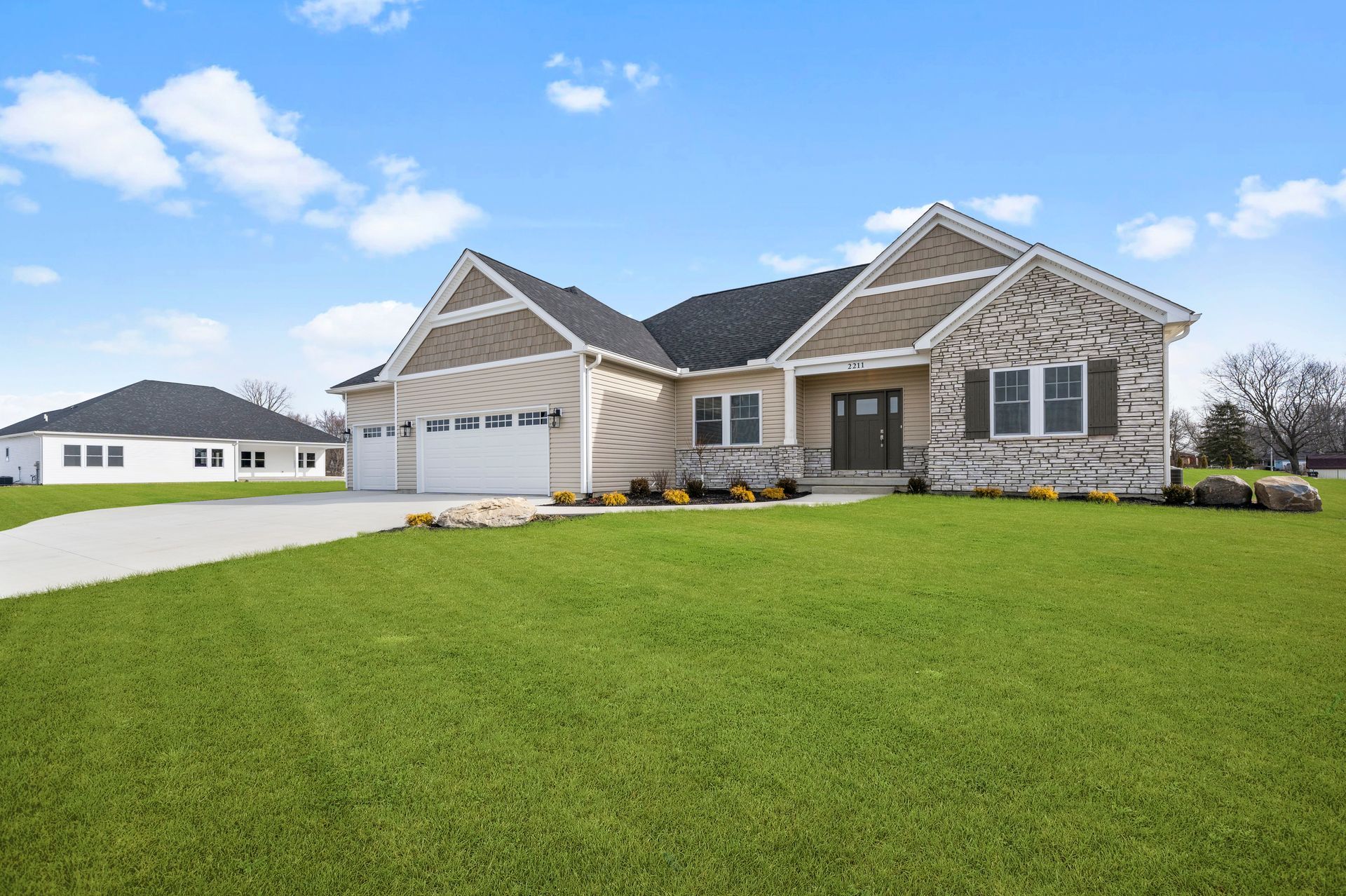 A large house with a large lawn in front of it.