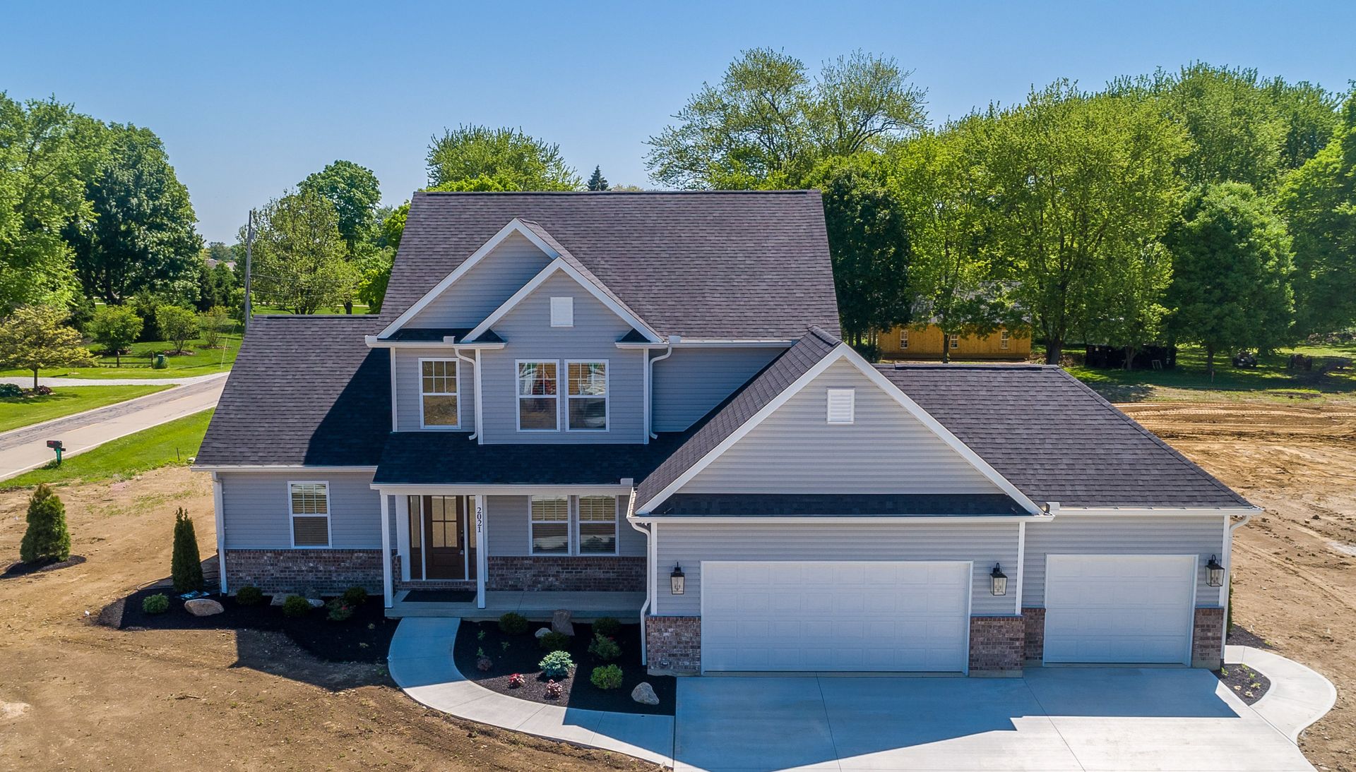 An aerial view of a house with a black roof