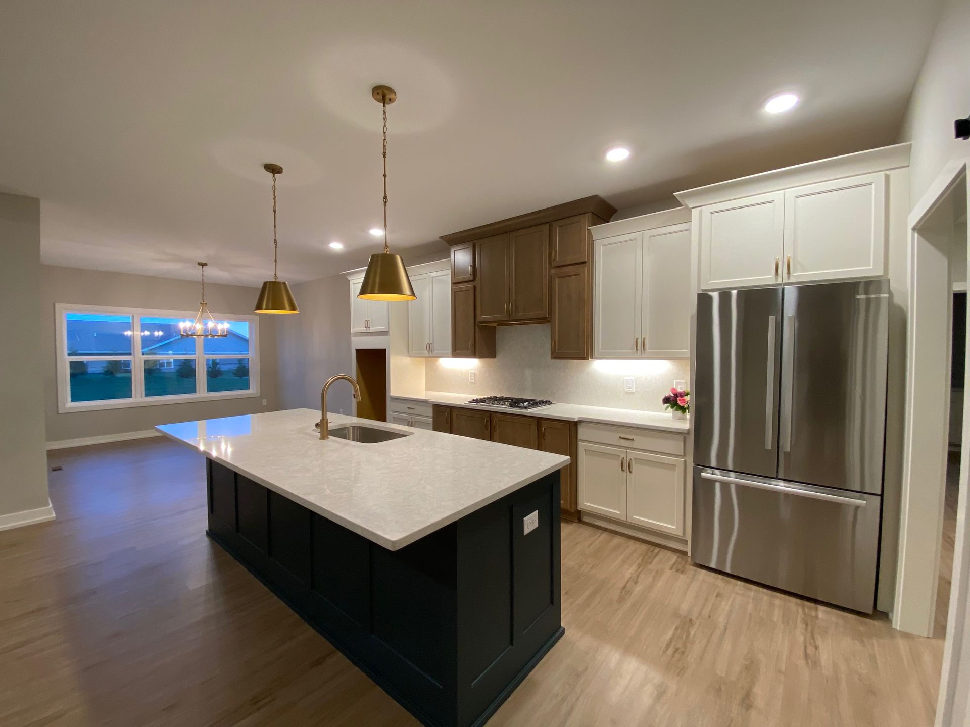 A kitchen with stainless steel appliances and a large island.