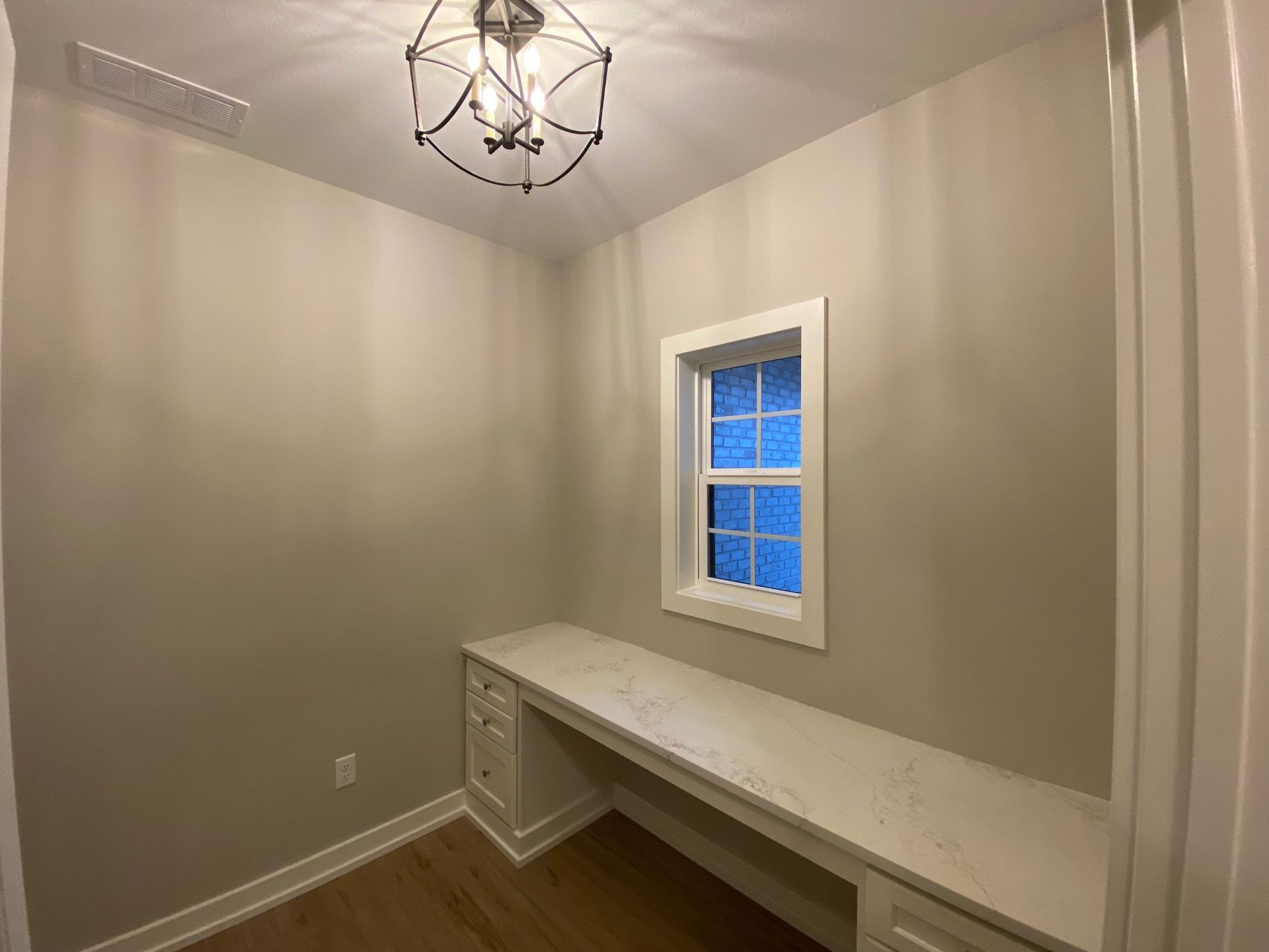 A small room with a desk and a window.
