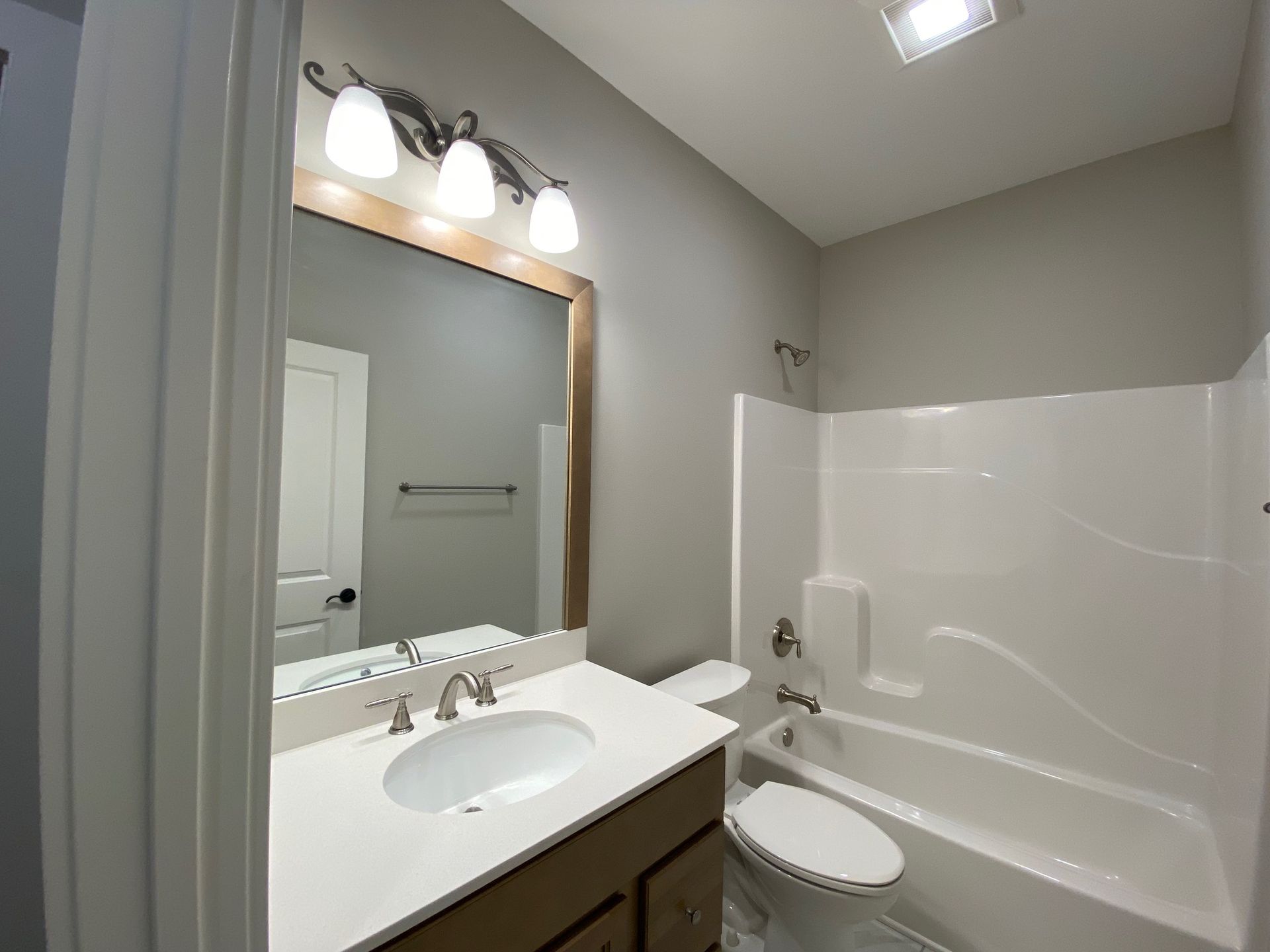 A bathroom with a sink , toilet and bathtub