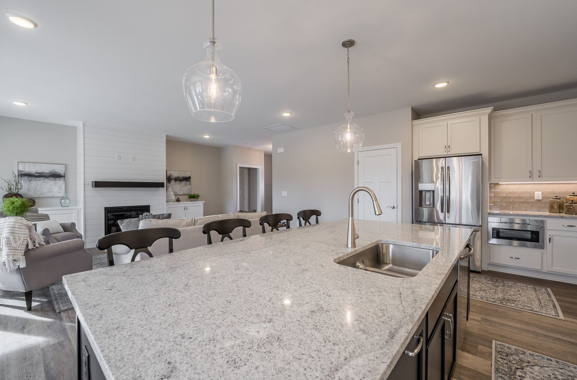 A kitchen with a large island and a sink.