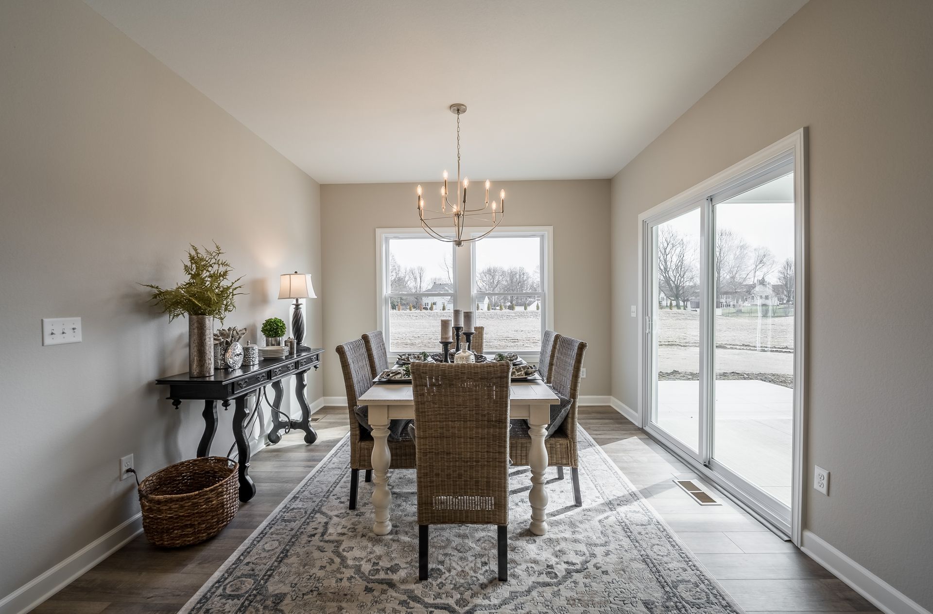 A dining room with a table and chairs and a chandelier.