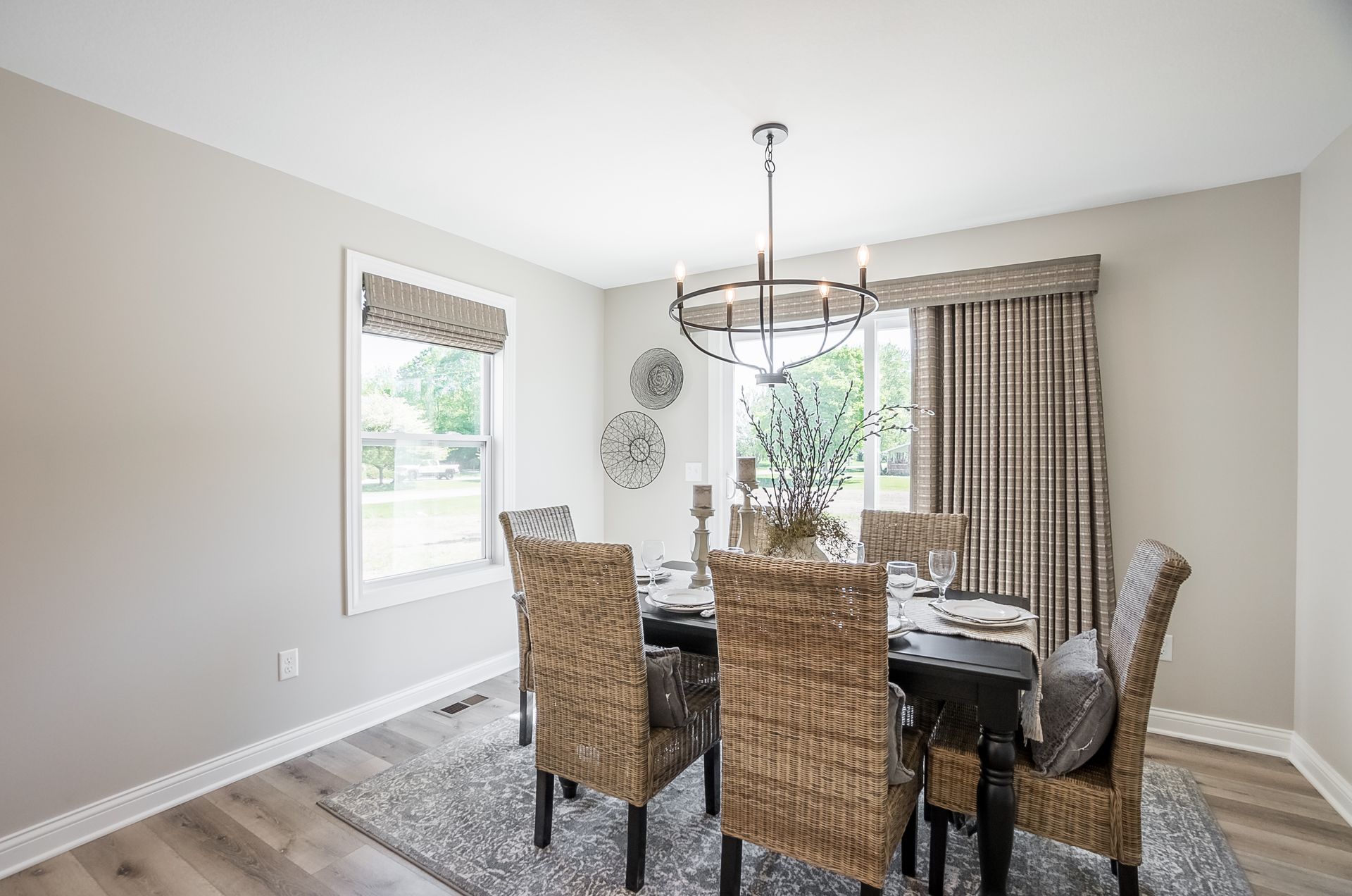 A dining room with a table and chairs and a chandelier.