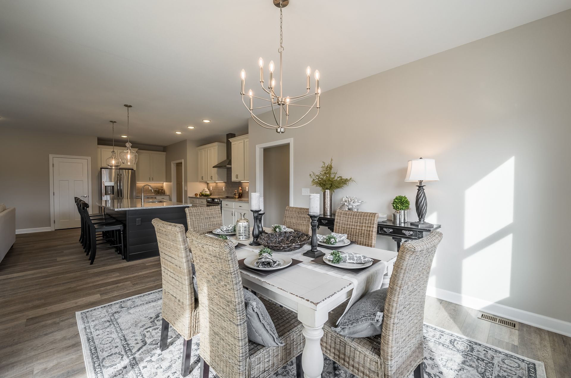A dining room with a table and chairs and a chandelier.