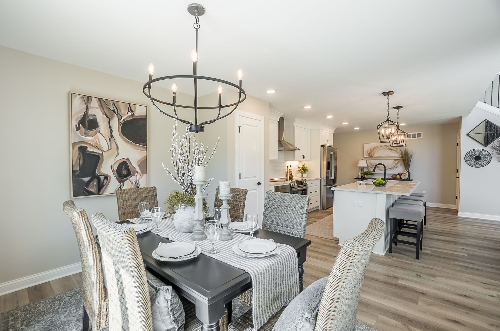 A dining room with a table and chairs and a chandelier.