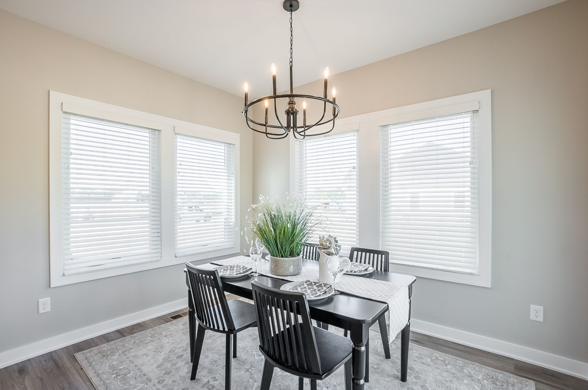 A dining room with a table and chairs and a chandelier.