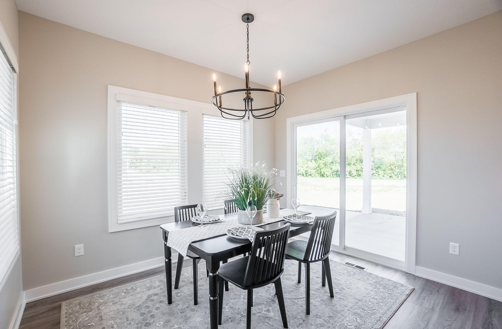A dining room with a table and chairs and a chandelier.