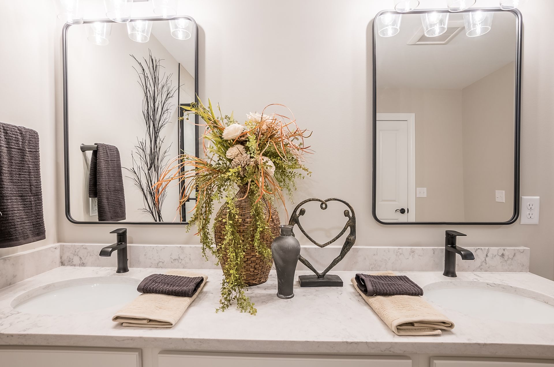 A bathroom with two sinks and two mirrors.