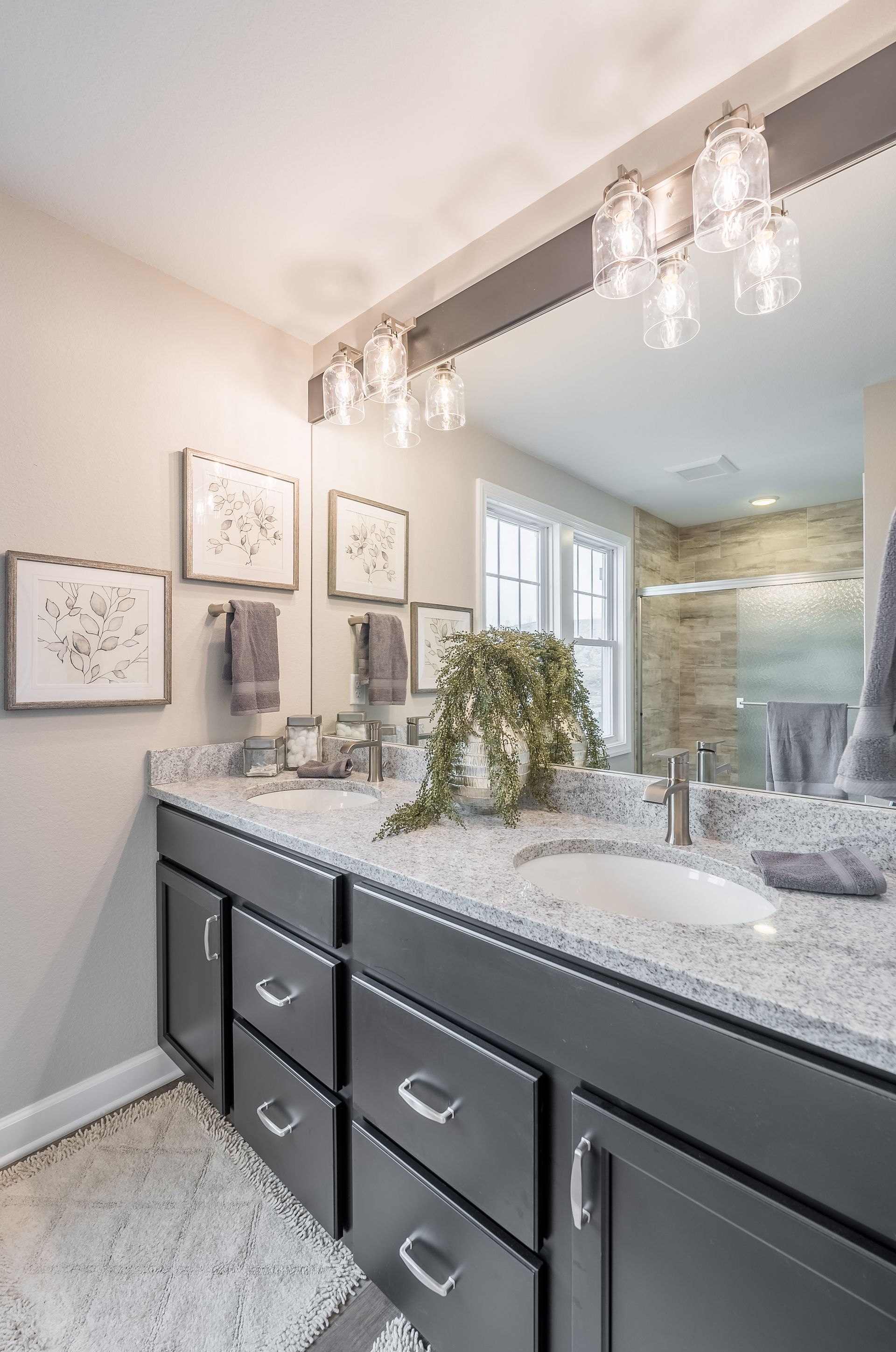 A bathroom with two sinks and a large mirror.