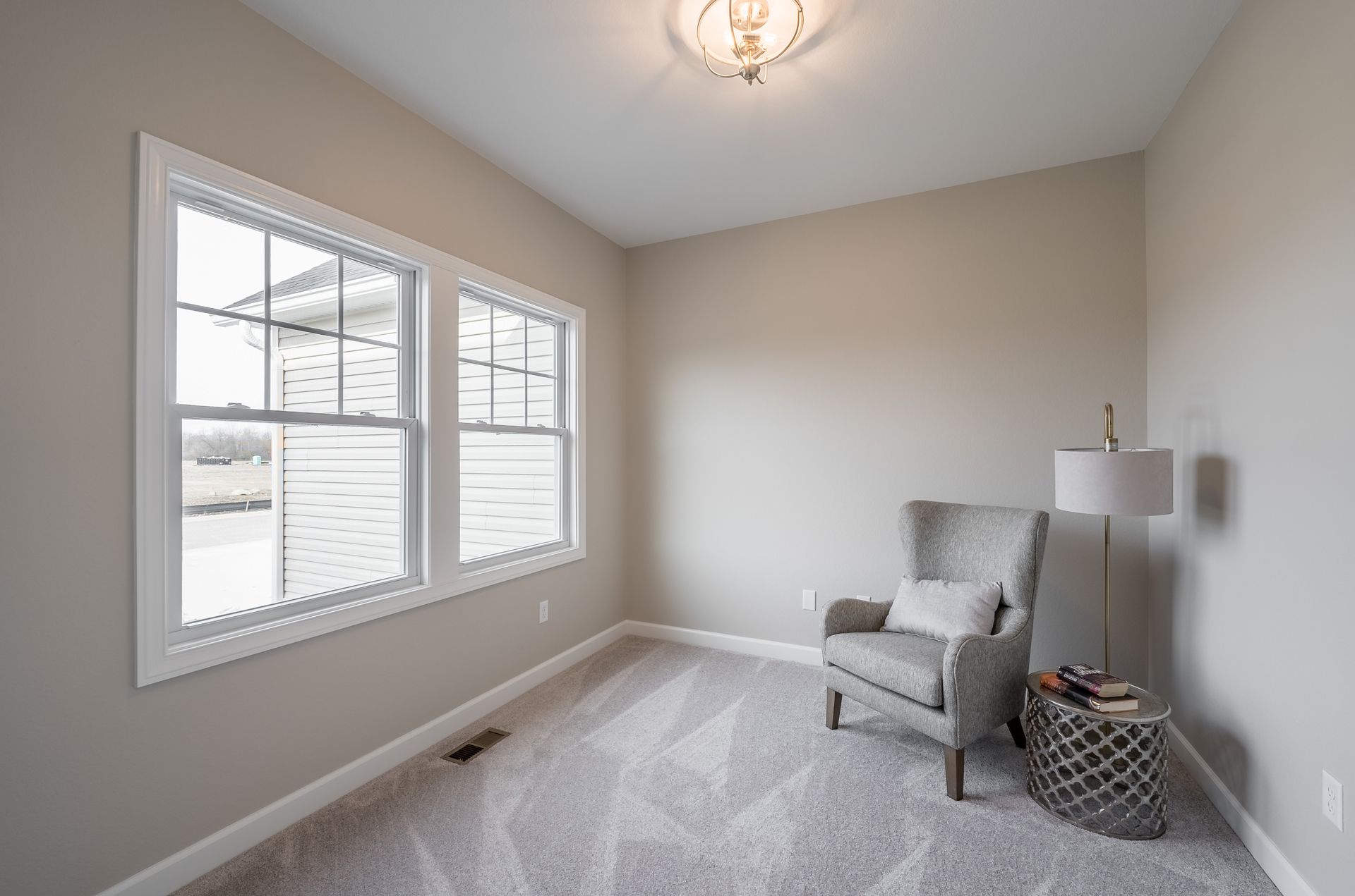 There is a chair and a lamp in the room.