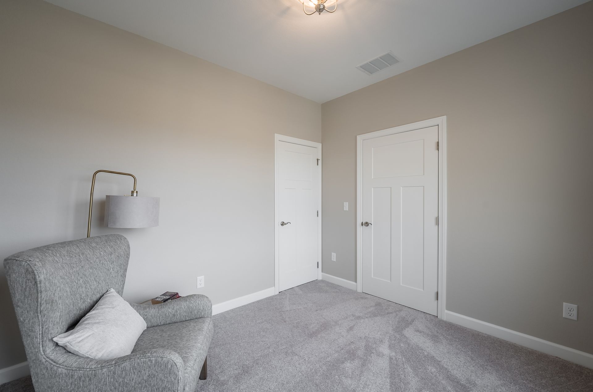 There is a chair and a lamp in the room.