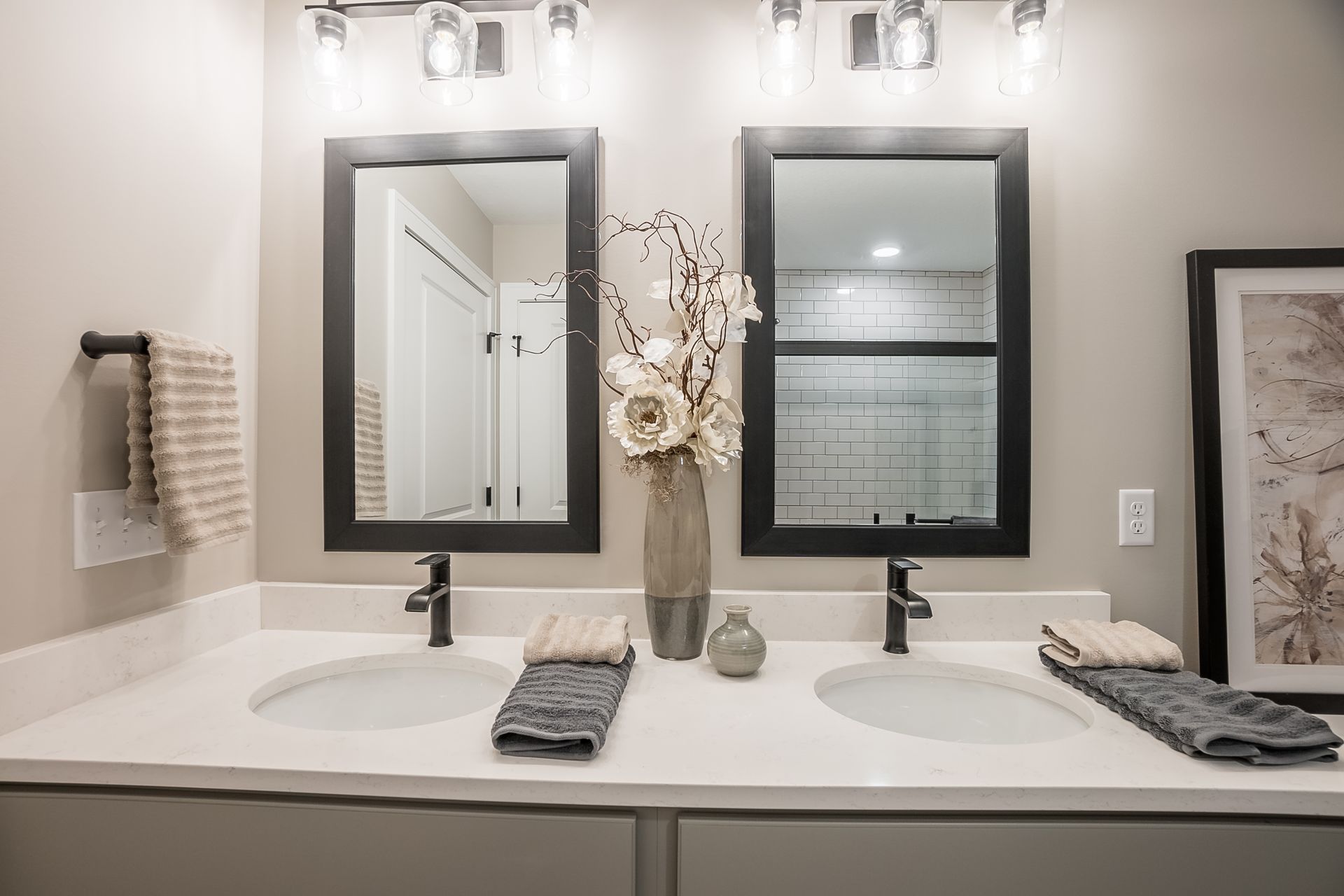 A bathroom with two sinks and two mirrors.