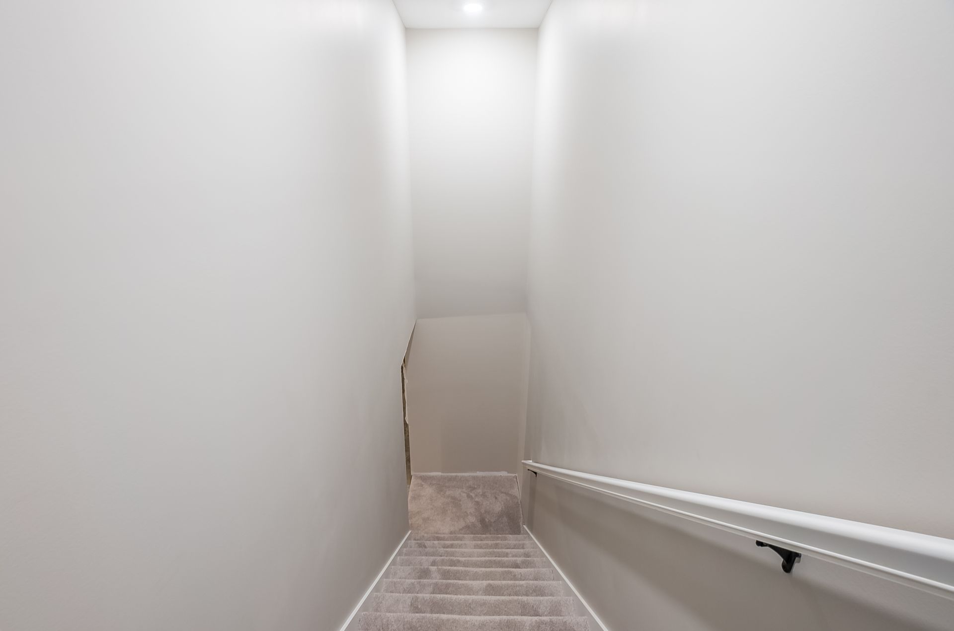 A set of stairs leading up to the second floor of a house.