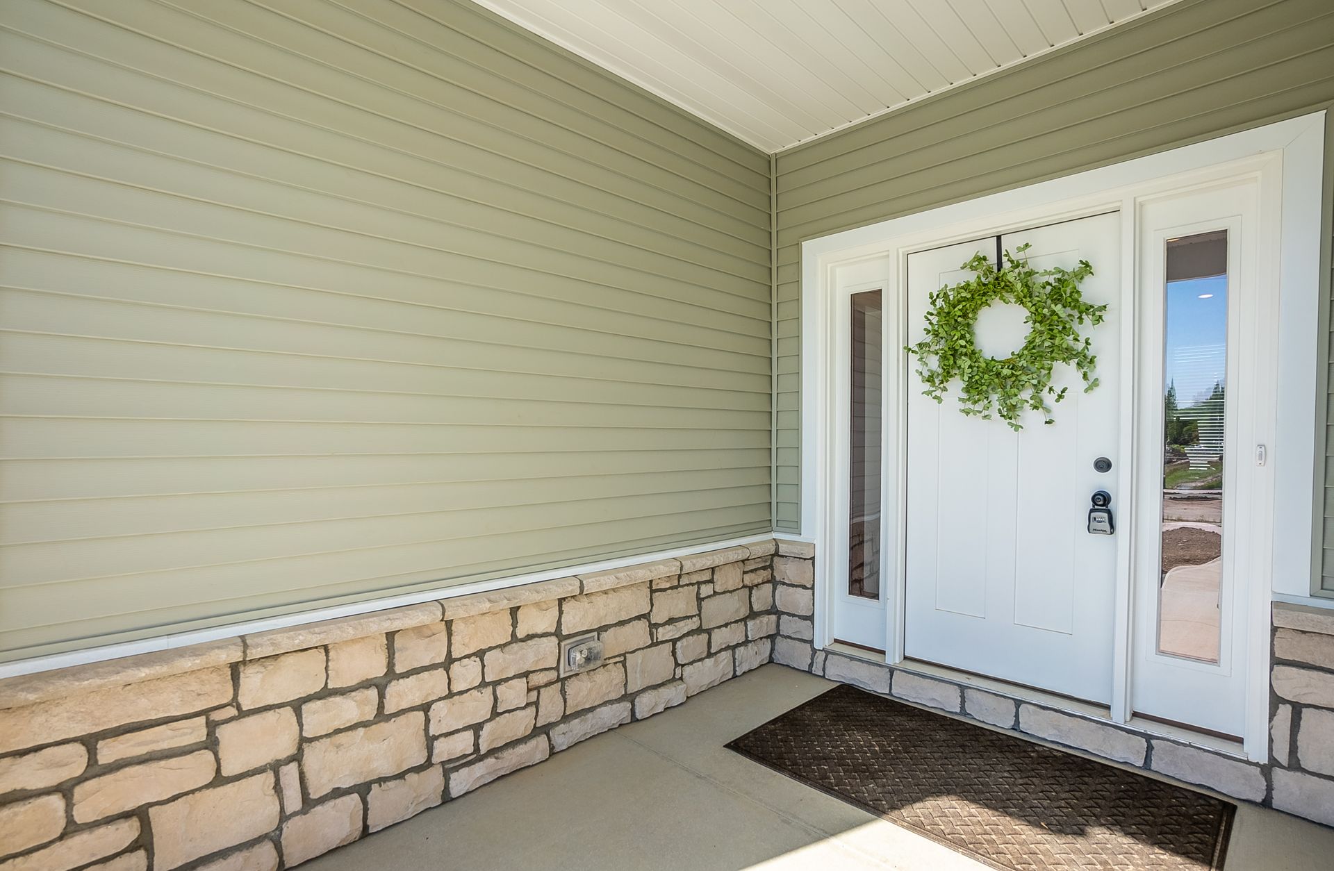 The front door of a house with a wreath on it.