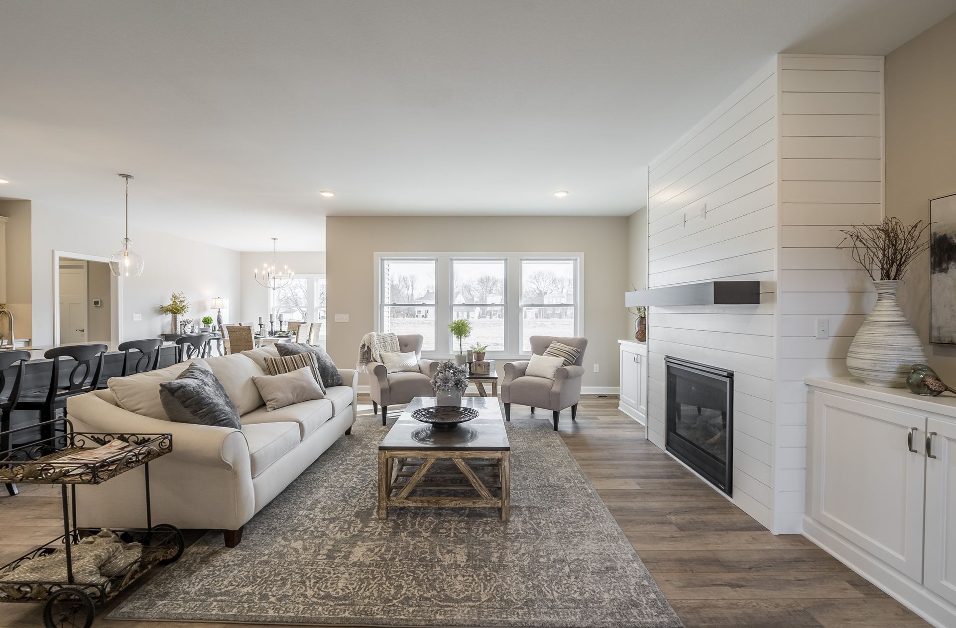A living room with a couch , chairs , coffee table and fireplace.