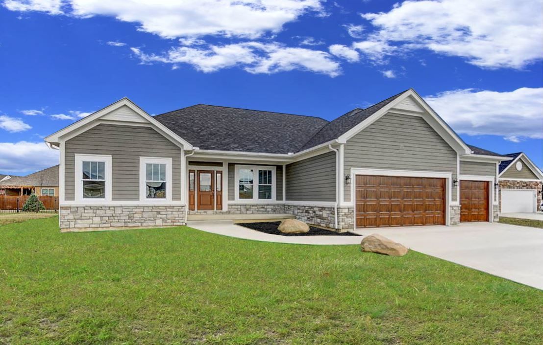A large house with a lot of grass in front of it.