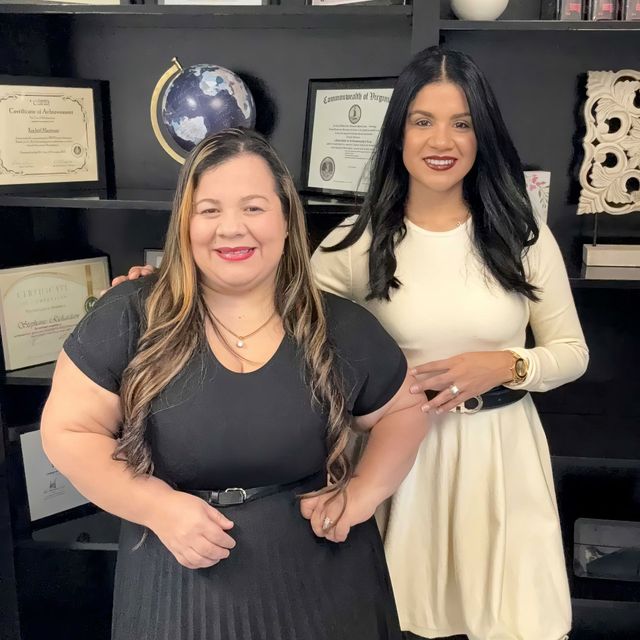 Two women are posing for a picture in front of a globe