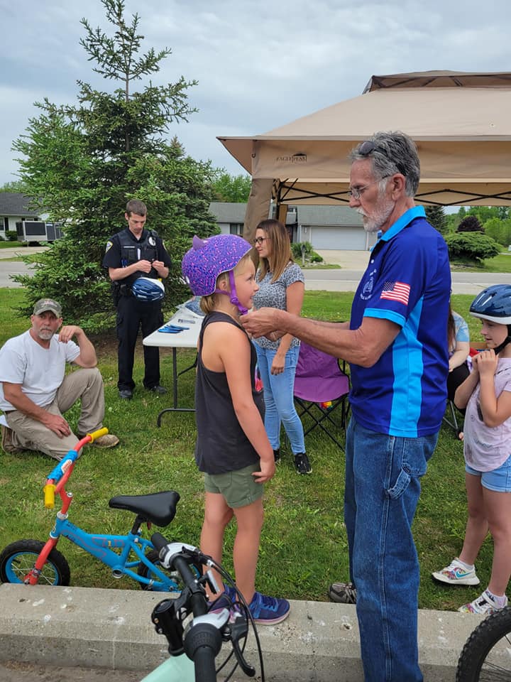 Man Fitting Child's Helmet