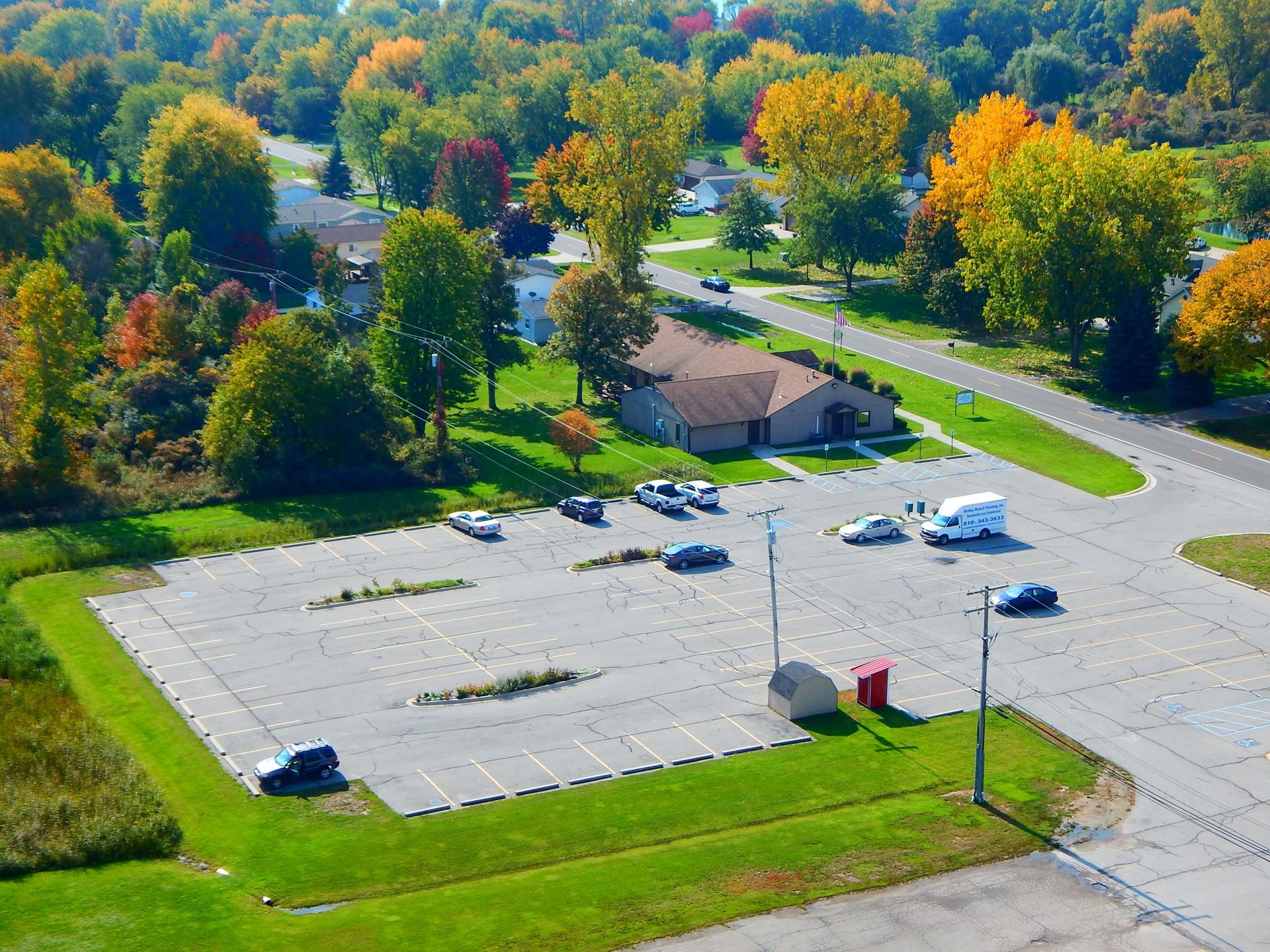 An aerial view of a parking lot surrounded by trees.