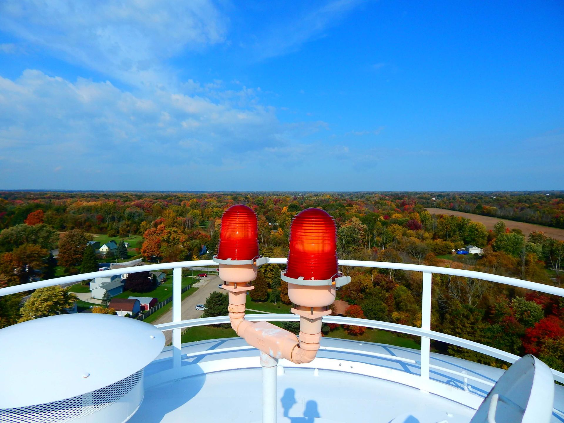A tower with two red lights on top of it.