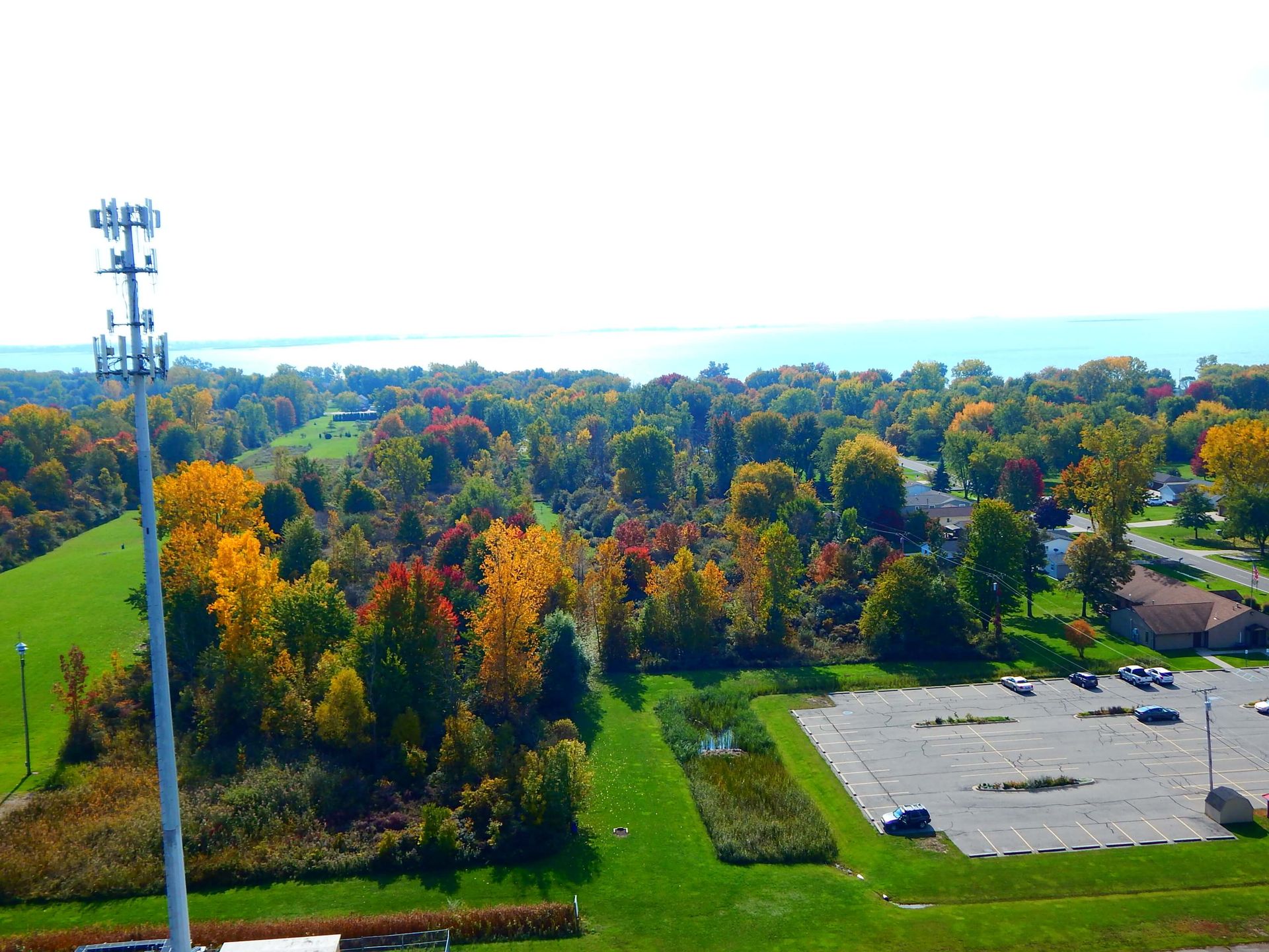An aerial view of a parking lot surrounded by trees.