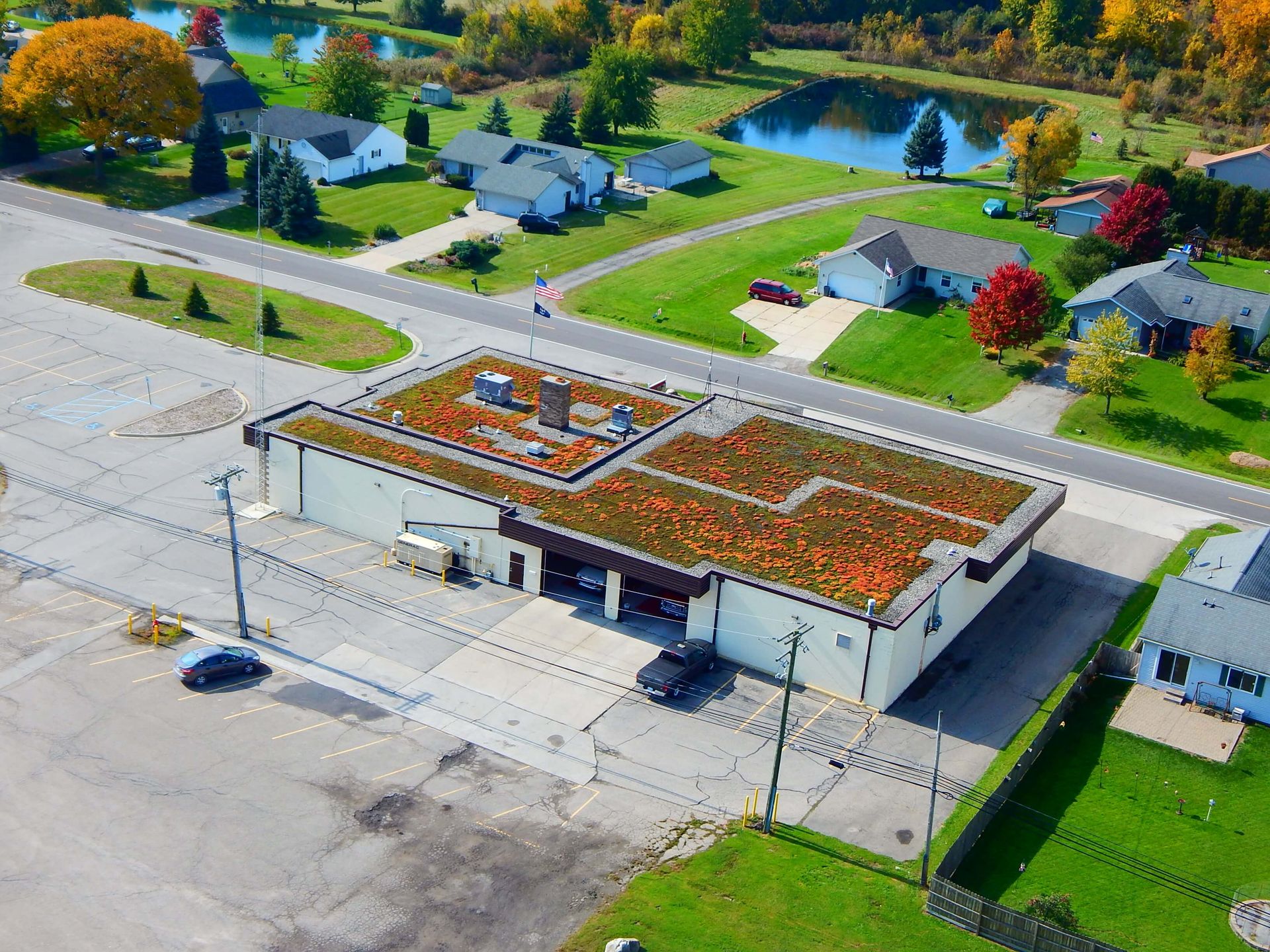 An aerial view of a building with a green roof.