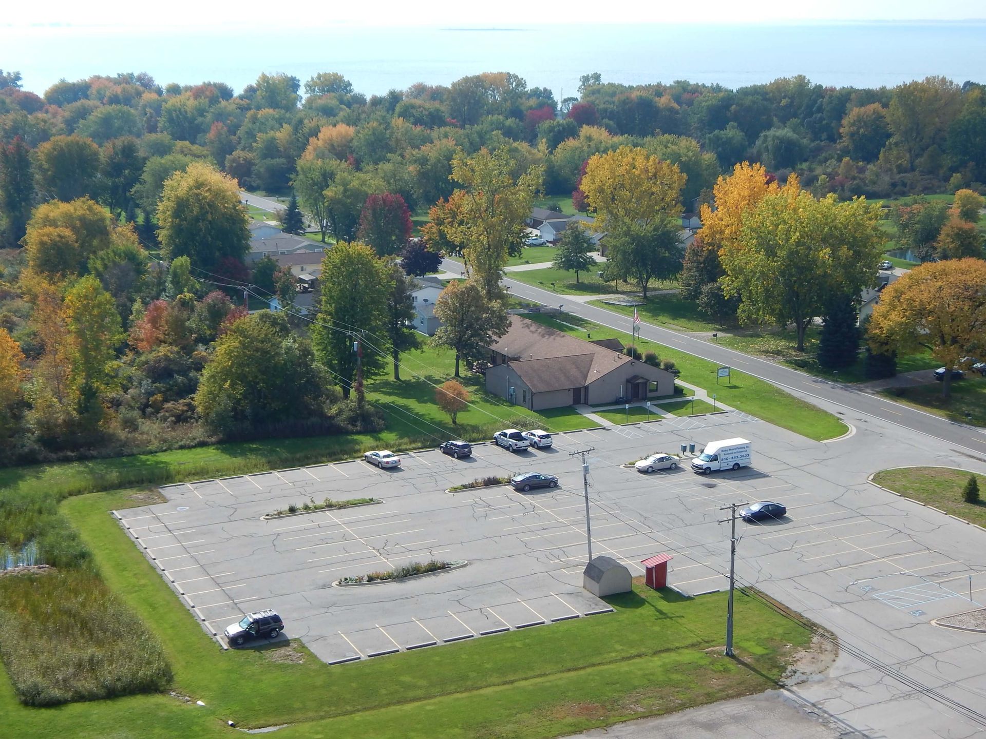 An aerial view of a parking lot surrounded by trees.