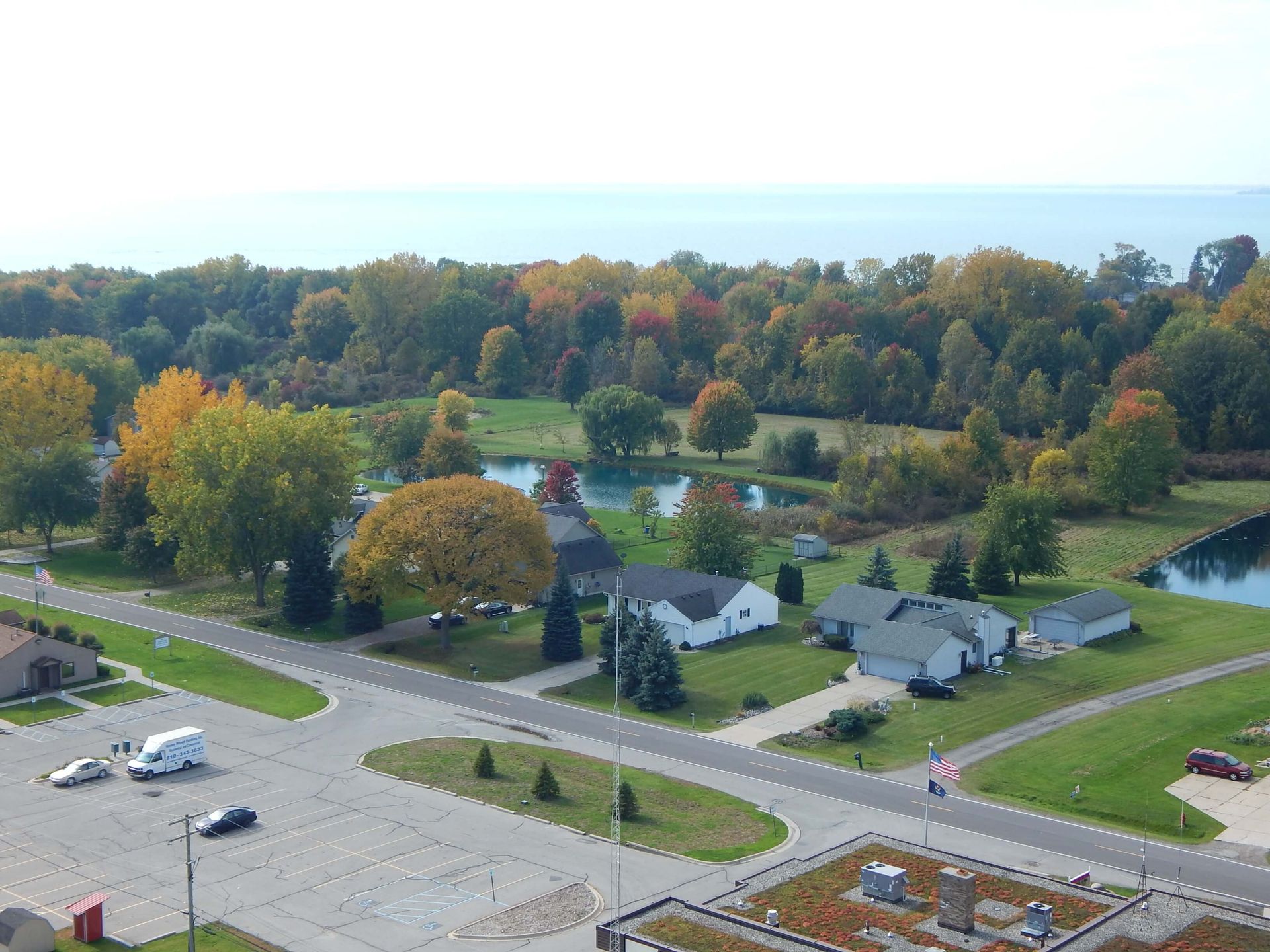 An aerial view of a residential area with a lake in the background.