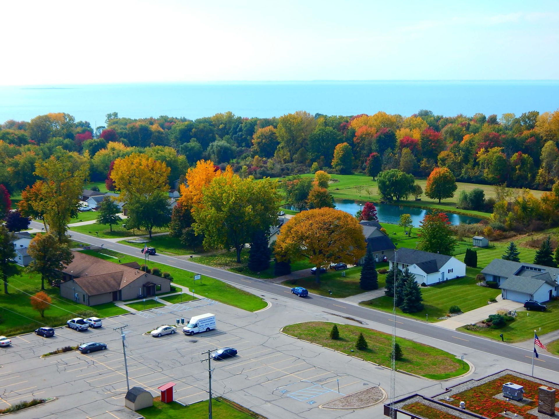 An aerial view of a residential area with a lake in the background.