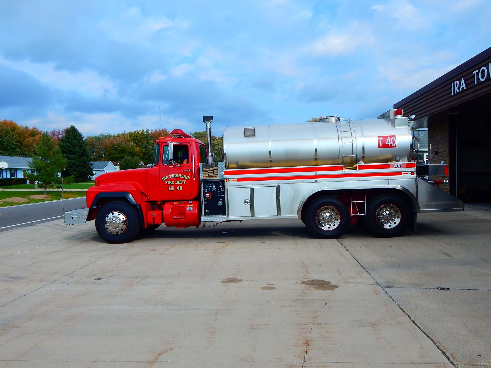 A red and silver truck with Ira Township written on the side.