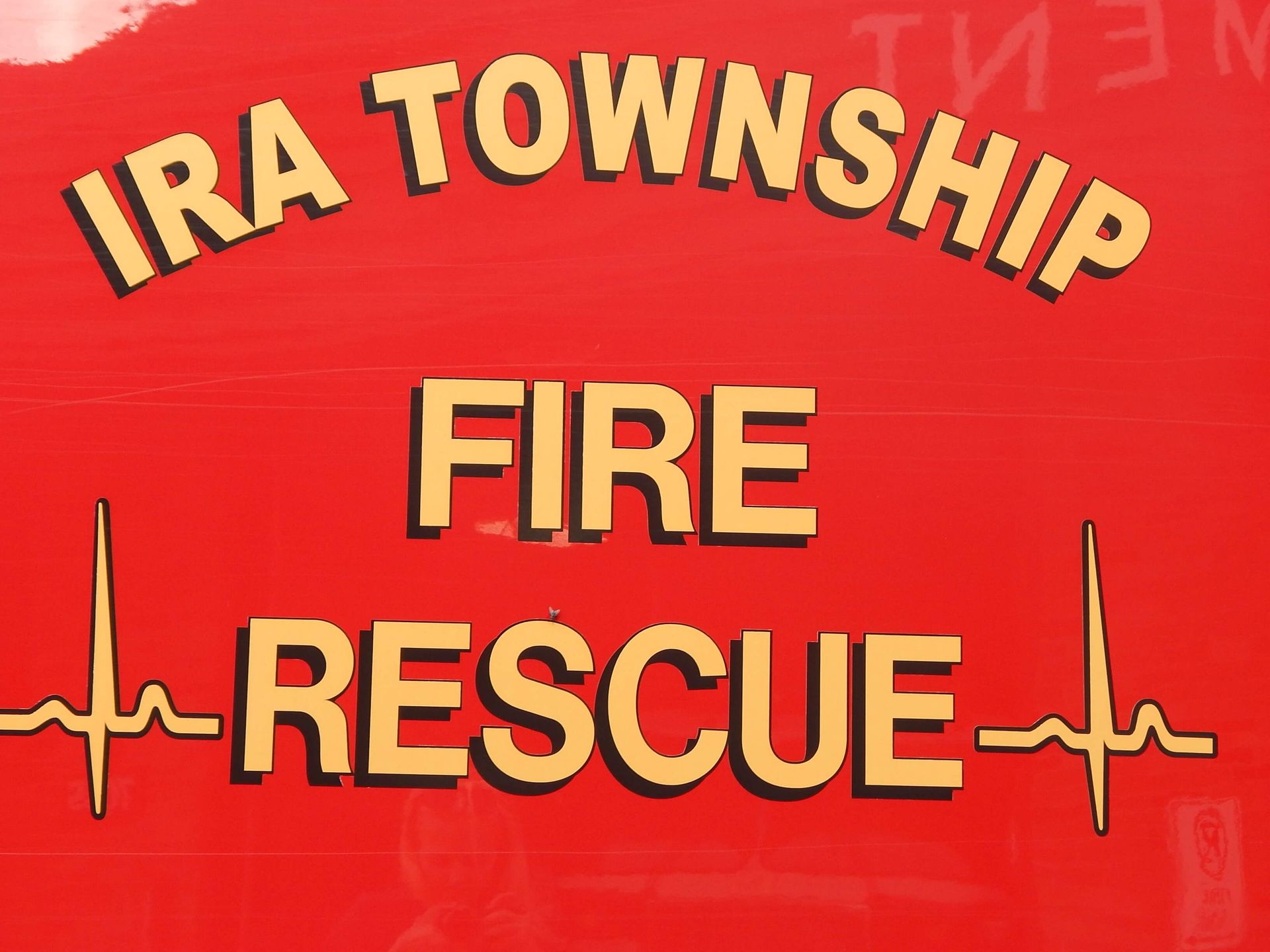 A red sign that says Ira Township Fire Rescue.