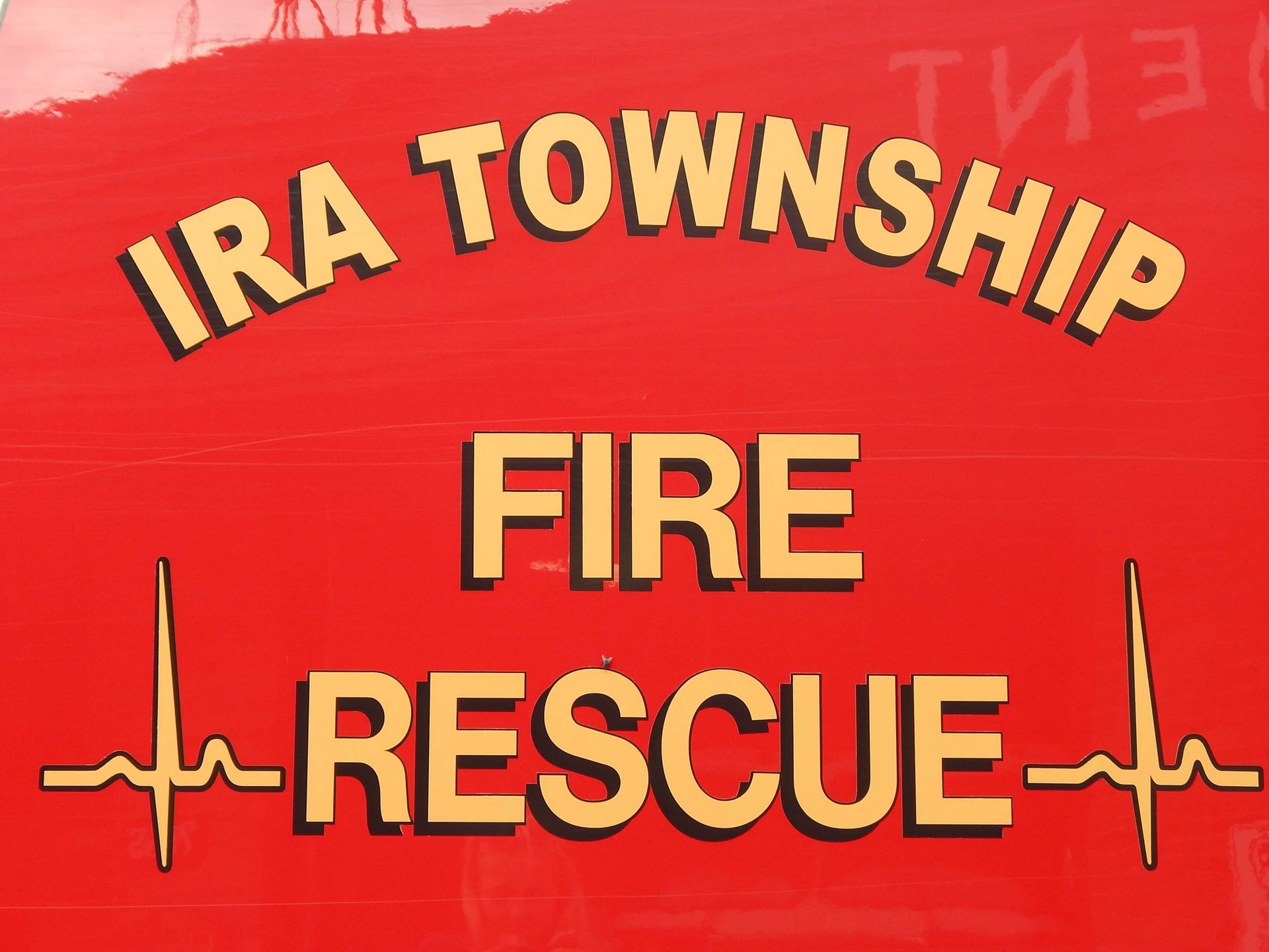 A red sign that says Ira Township Fire Rescue.