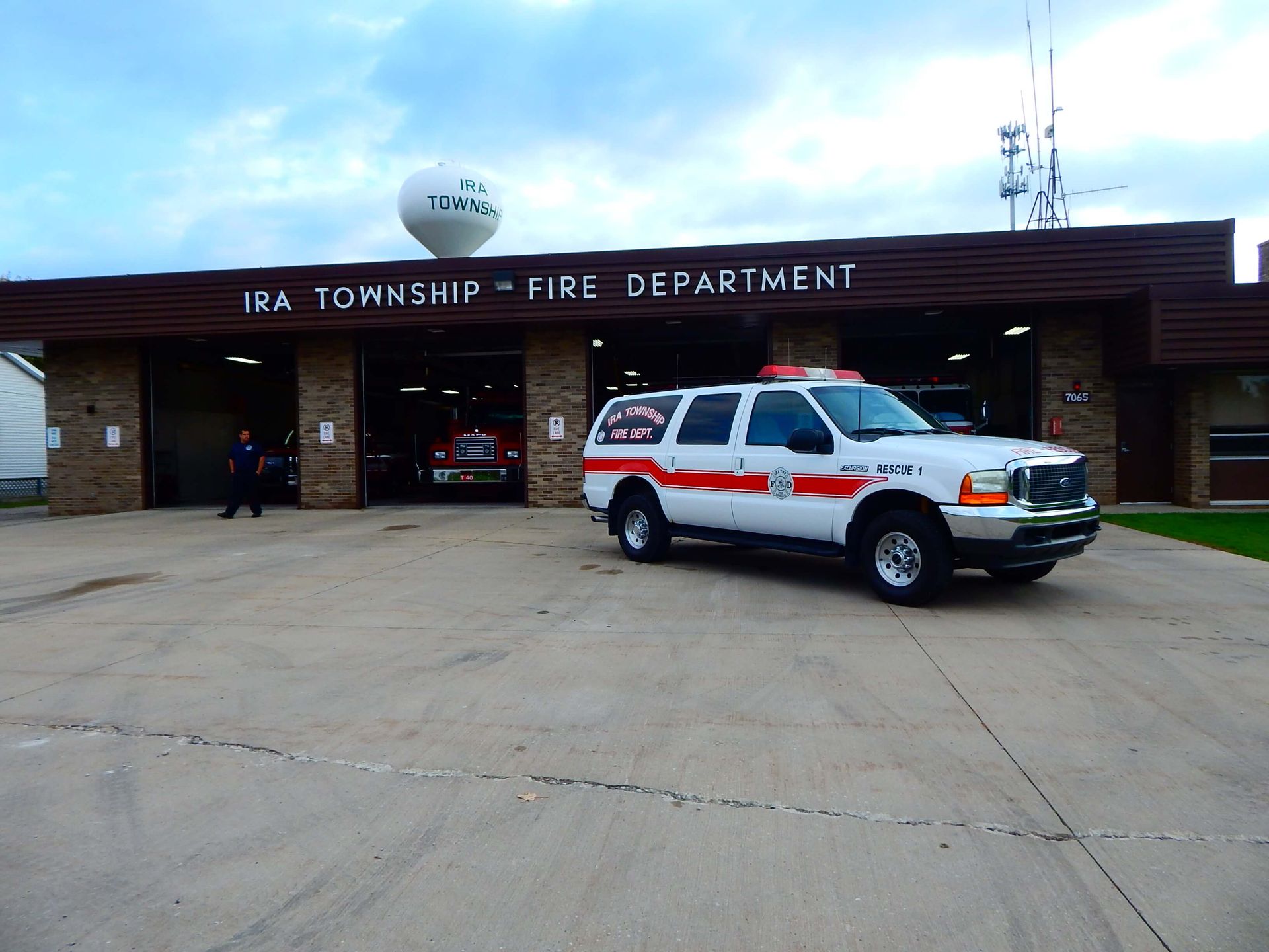 A fire rescue vehicle is parked in front of a fire department building.