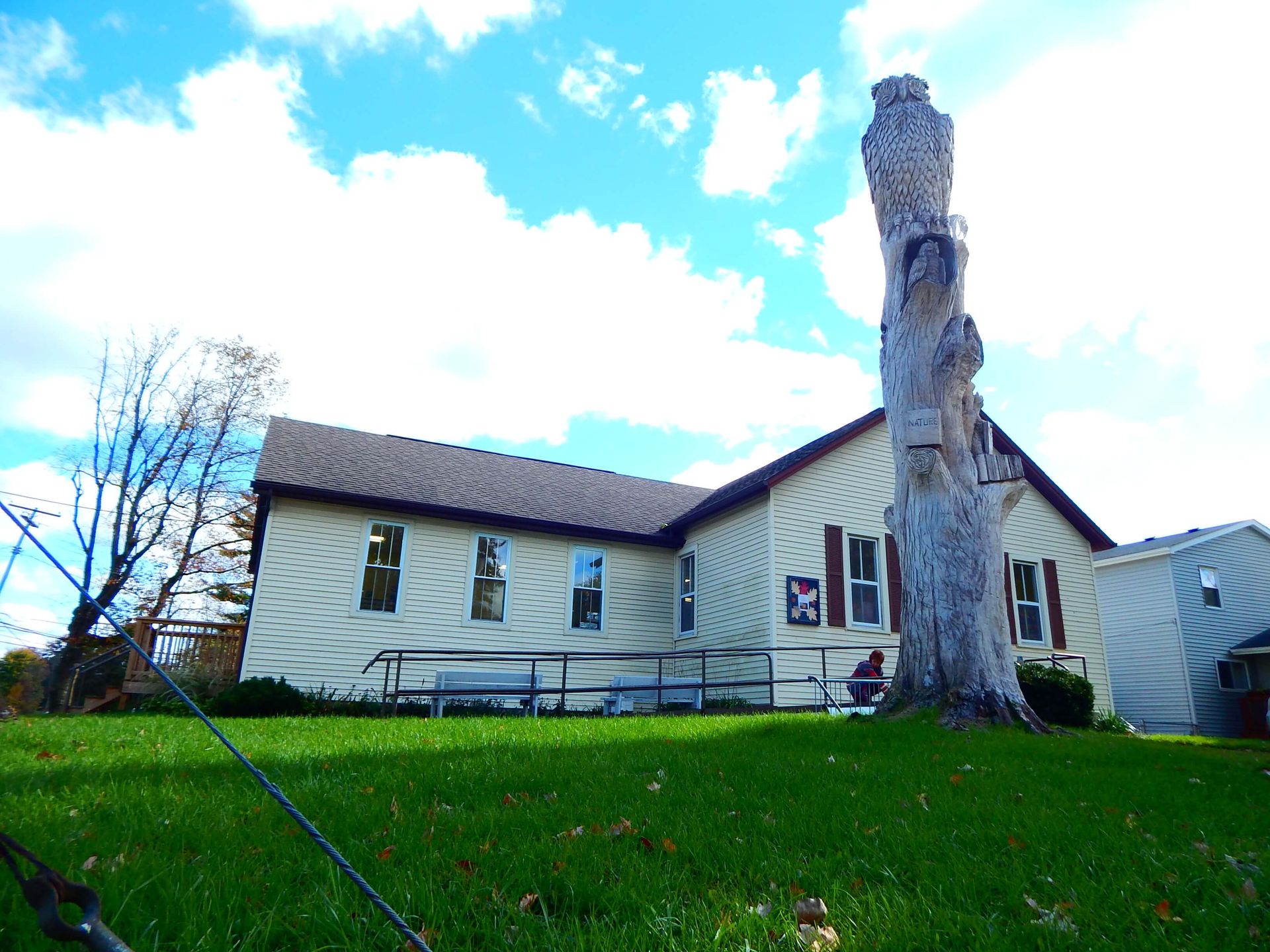 A large statue stands in front of Ira Township Library.