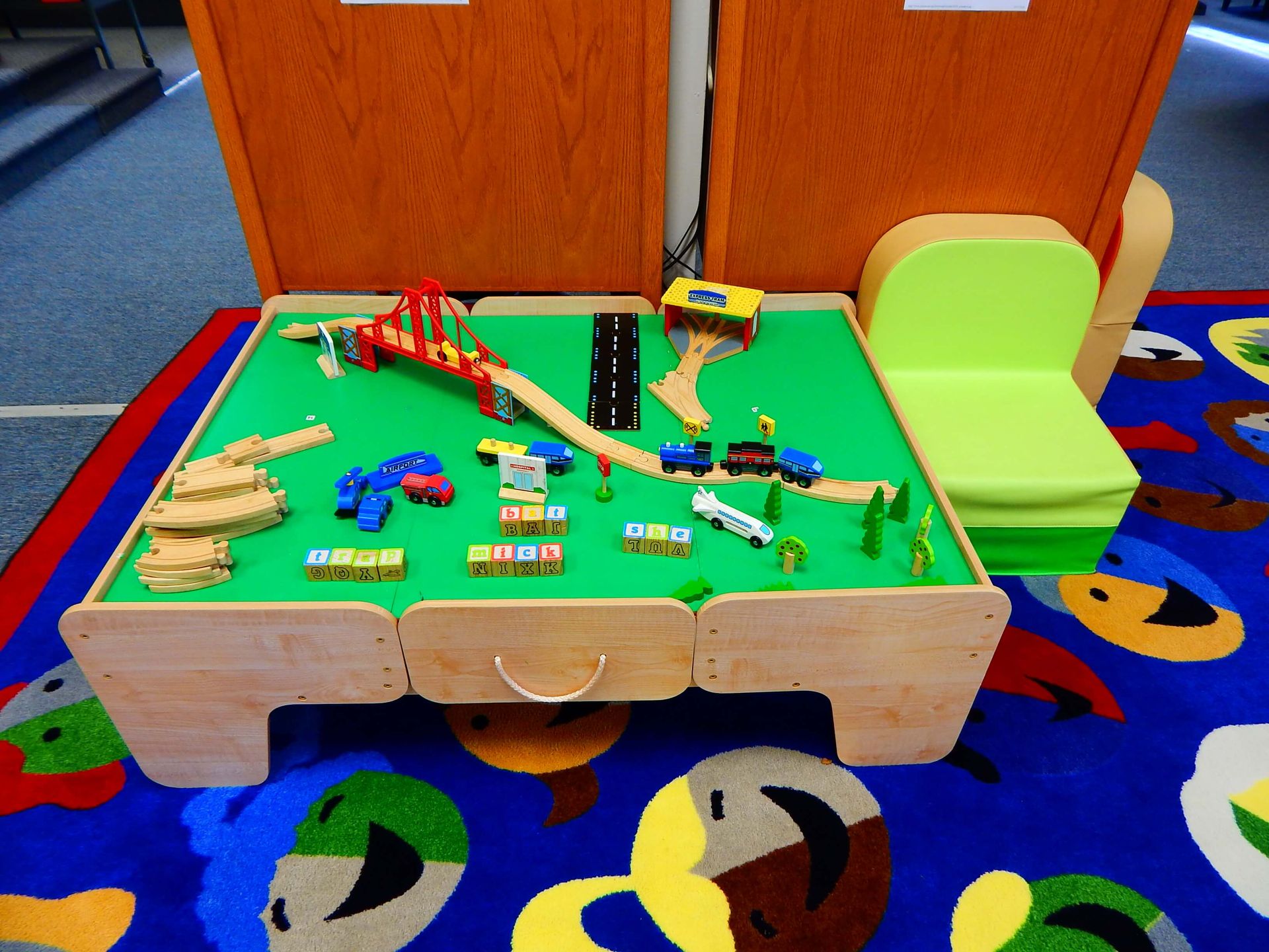 A wooden table with a train set on it.