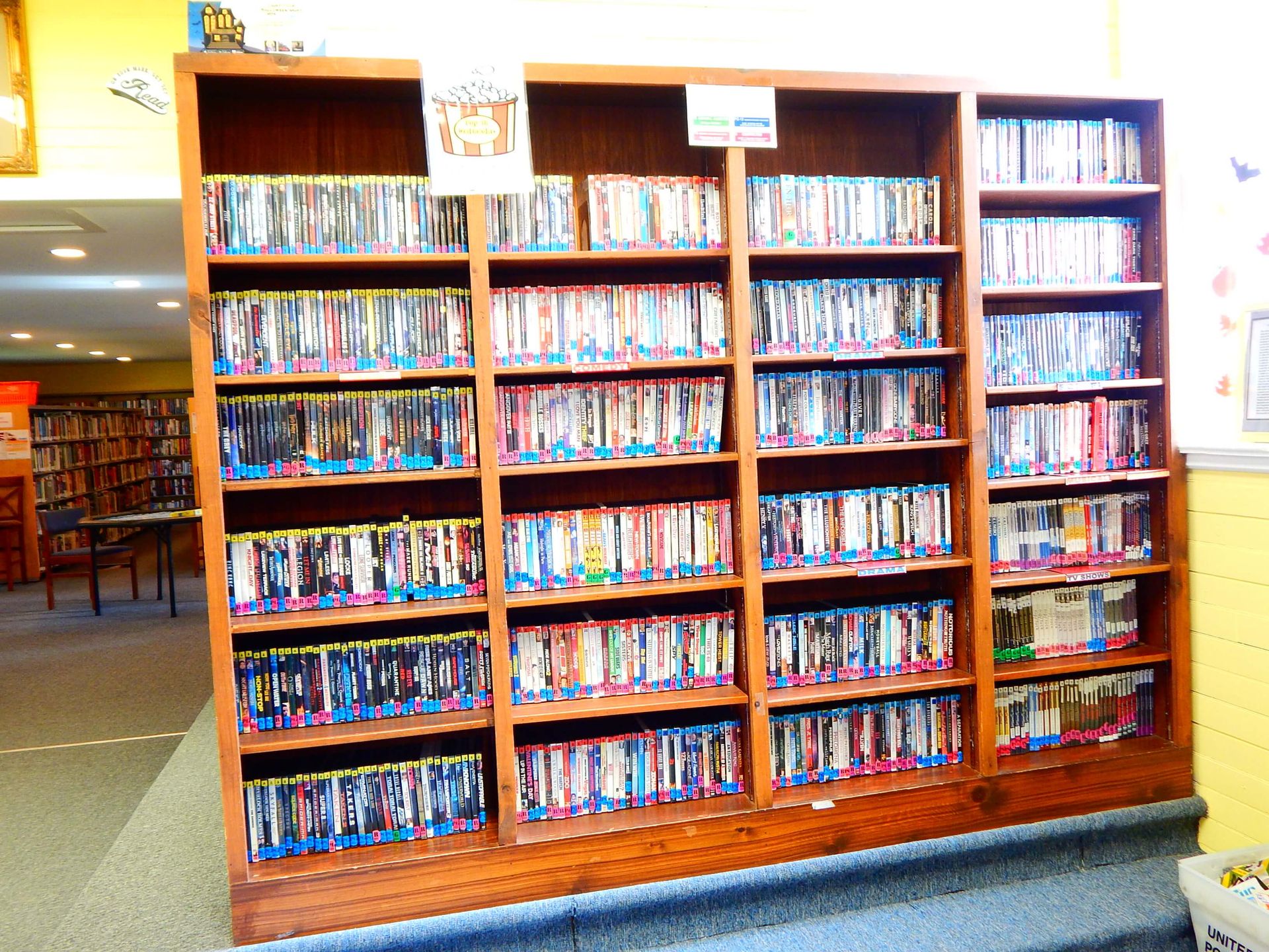 A row of bookshelves filled with lots of books.
