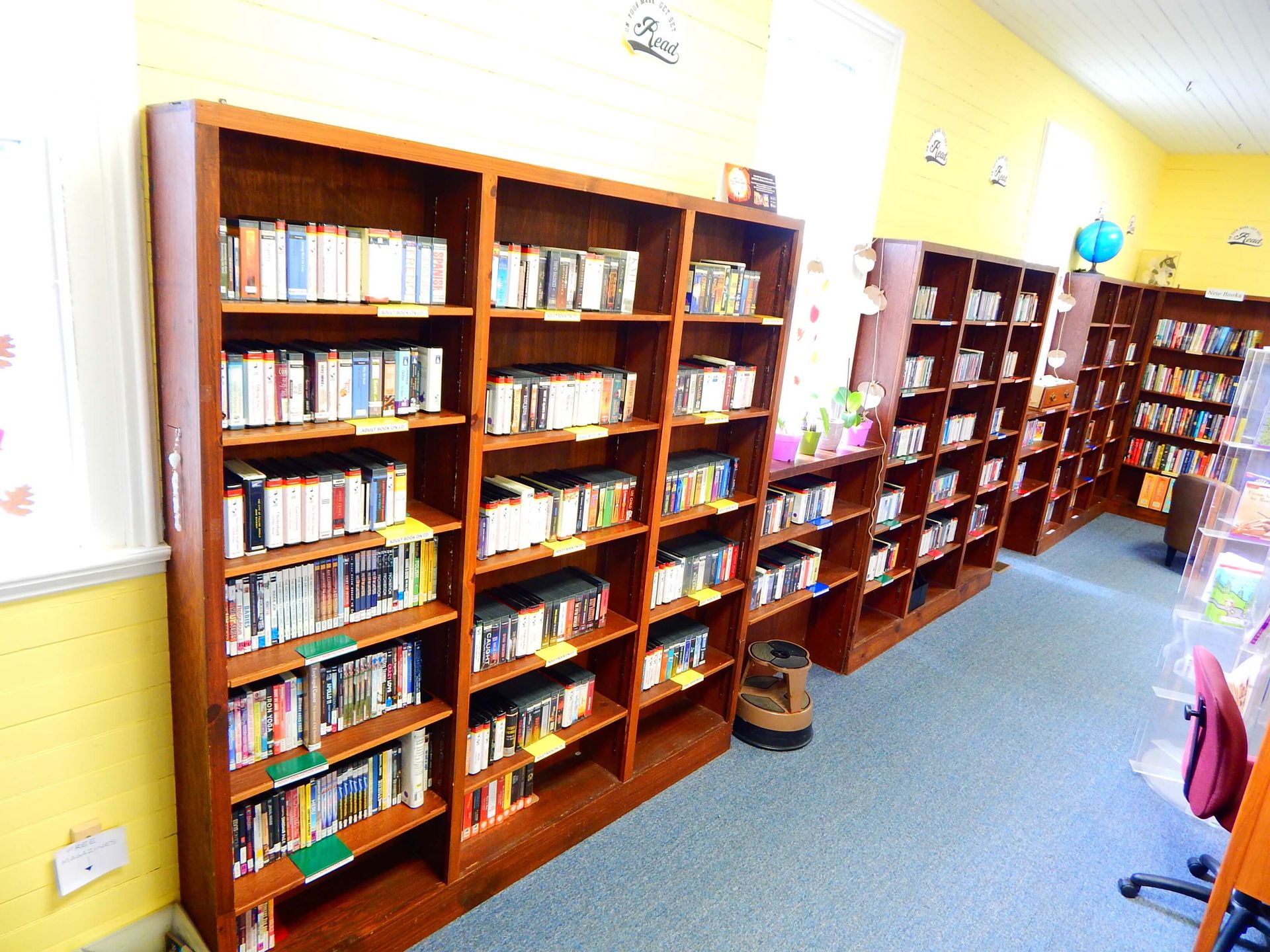 A library filled with lots of books and dvds.