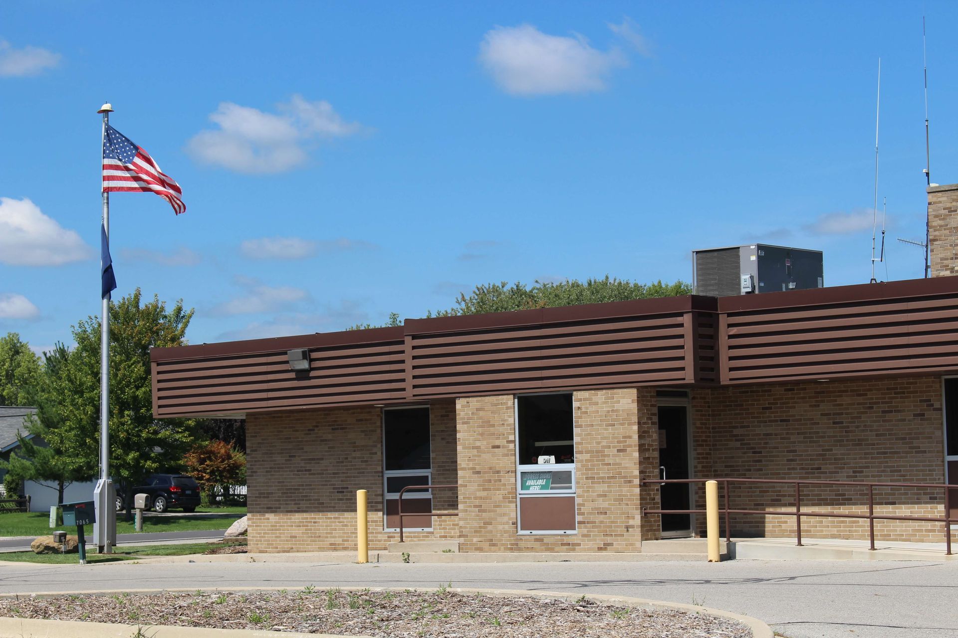 An American flag is flying in front of a building.