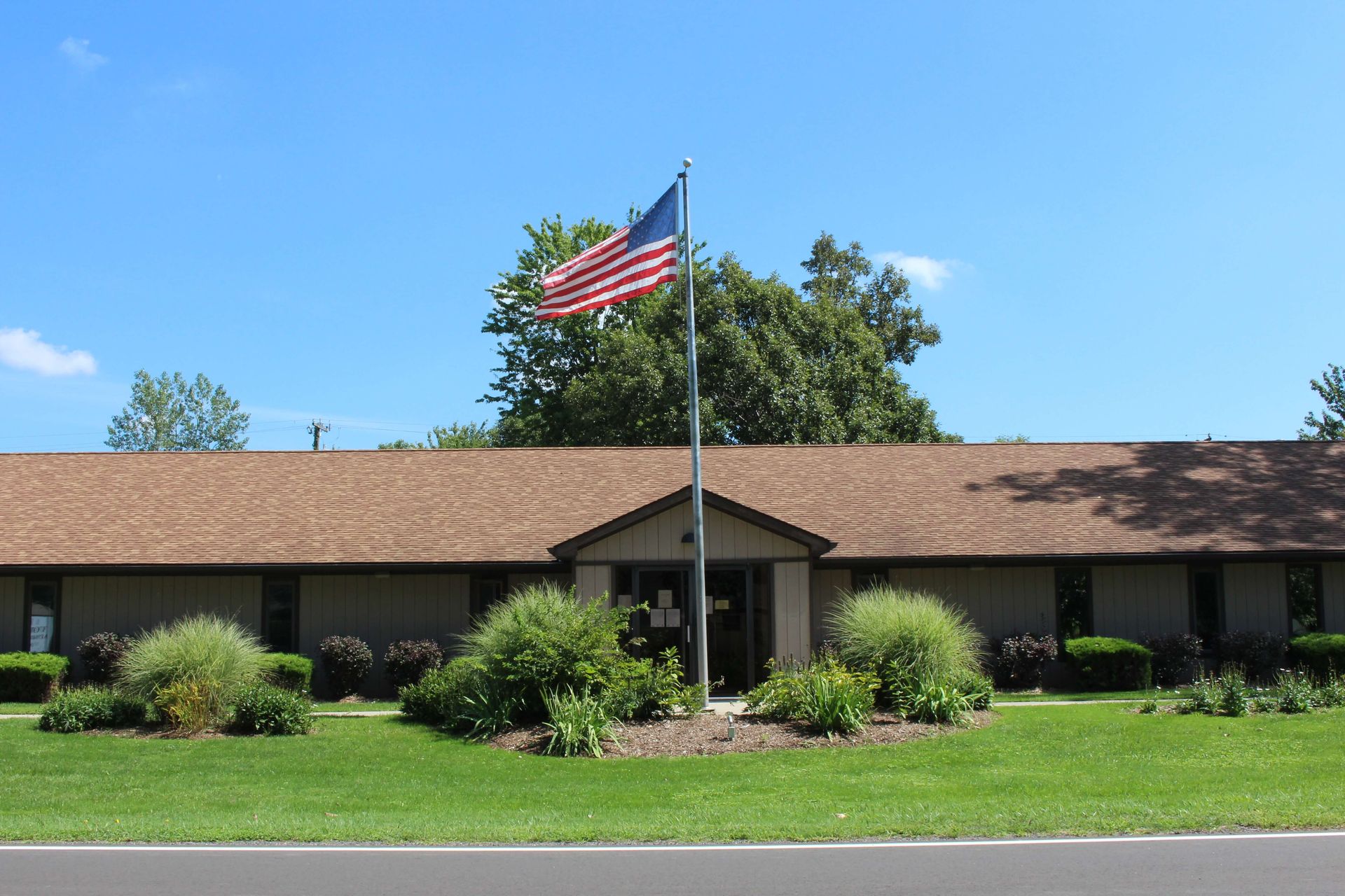 An American flag is flying in front of a building.