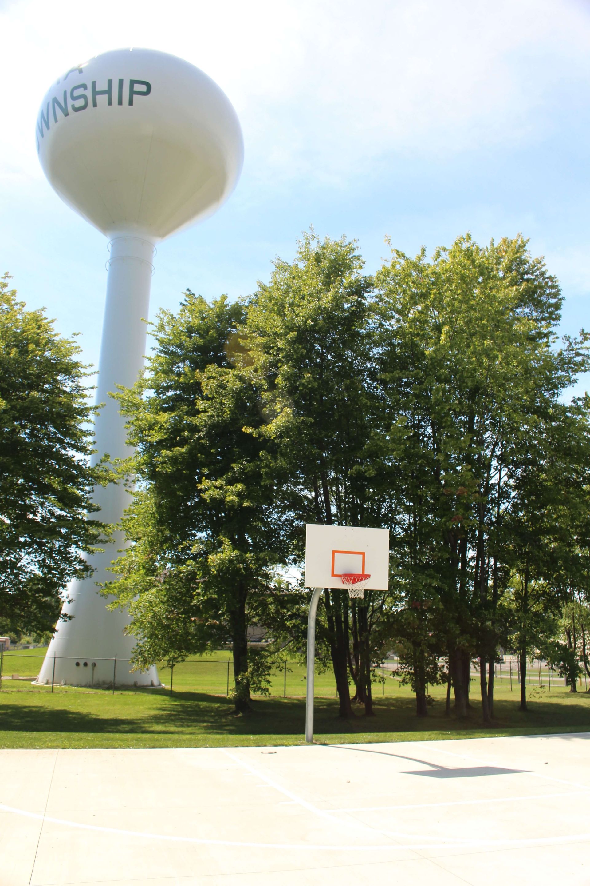 A basketball court with a water tower in the background.