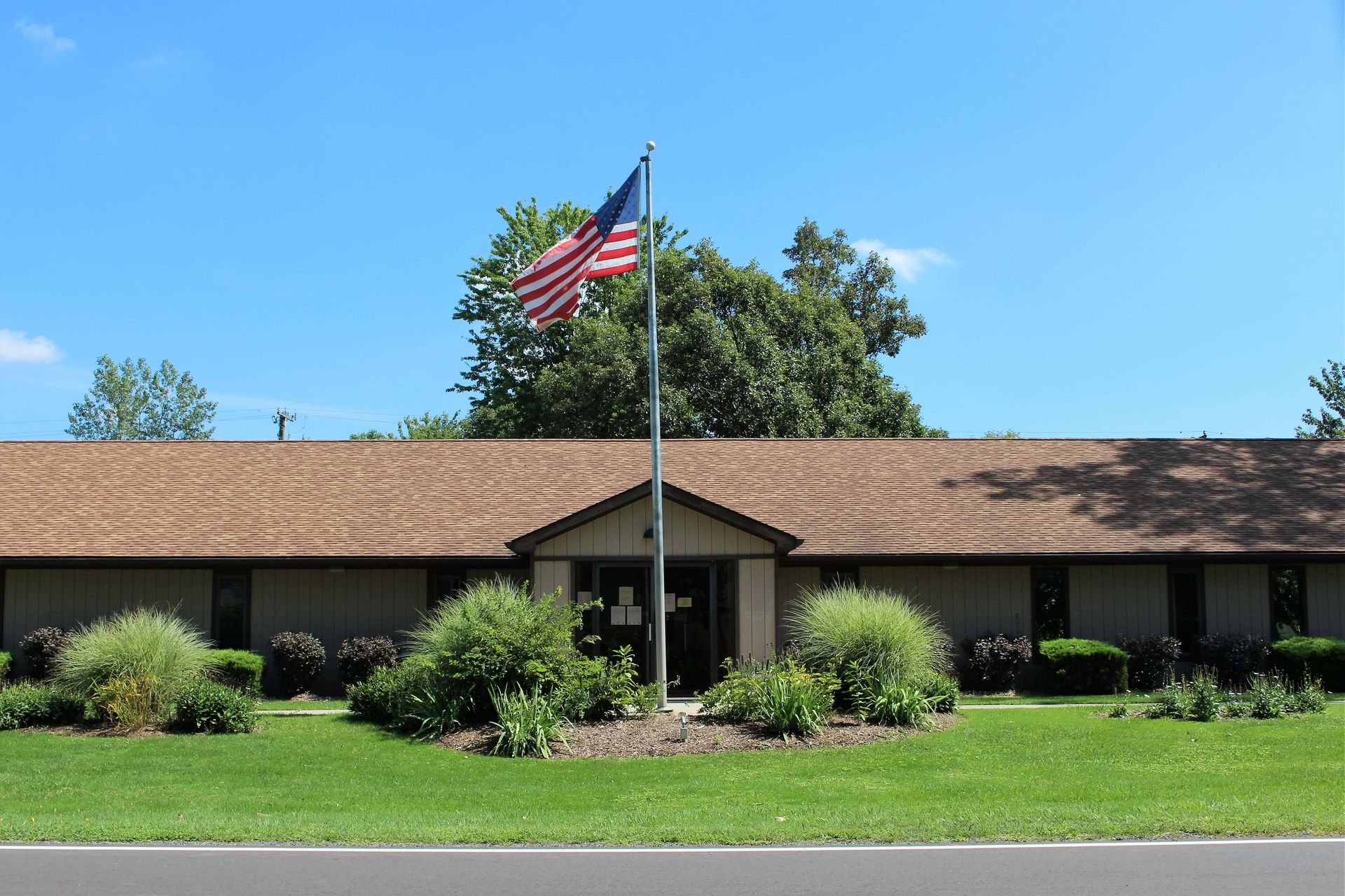 An American flag is flying in front of a building.