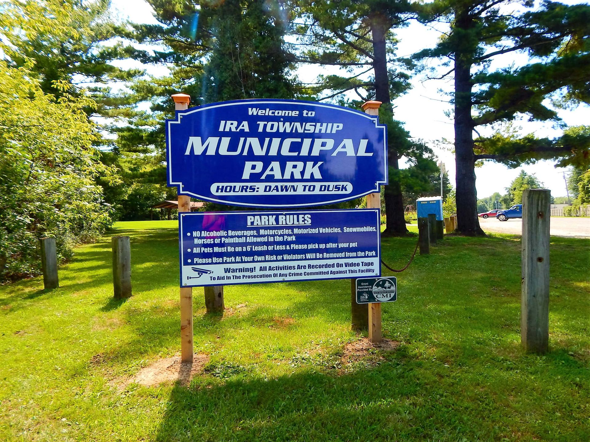 A blue sign that says Ira Township Municipal Park on it.