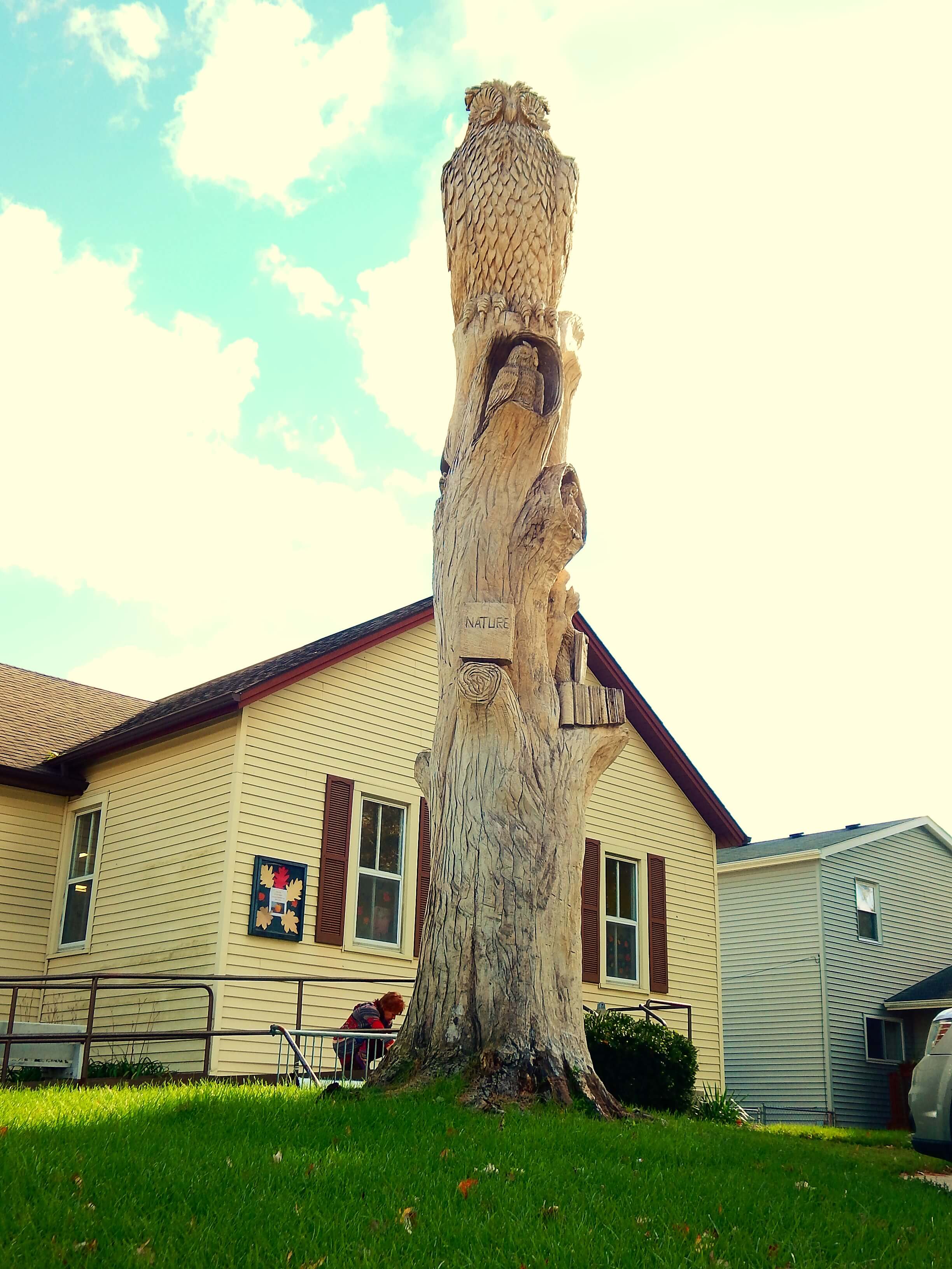 A house with a large statue in front of it.