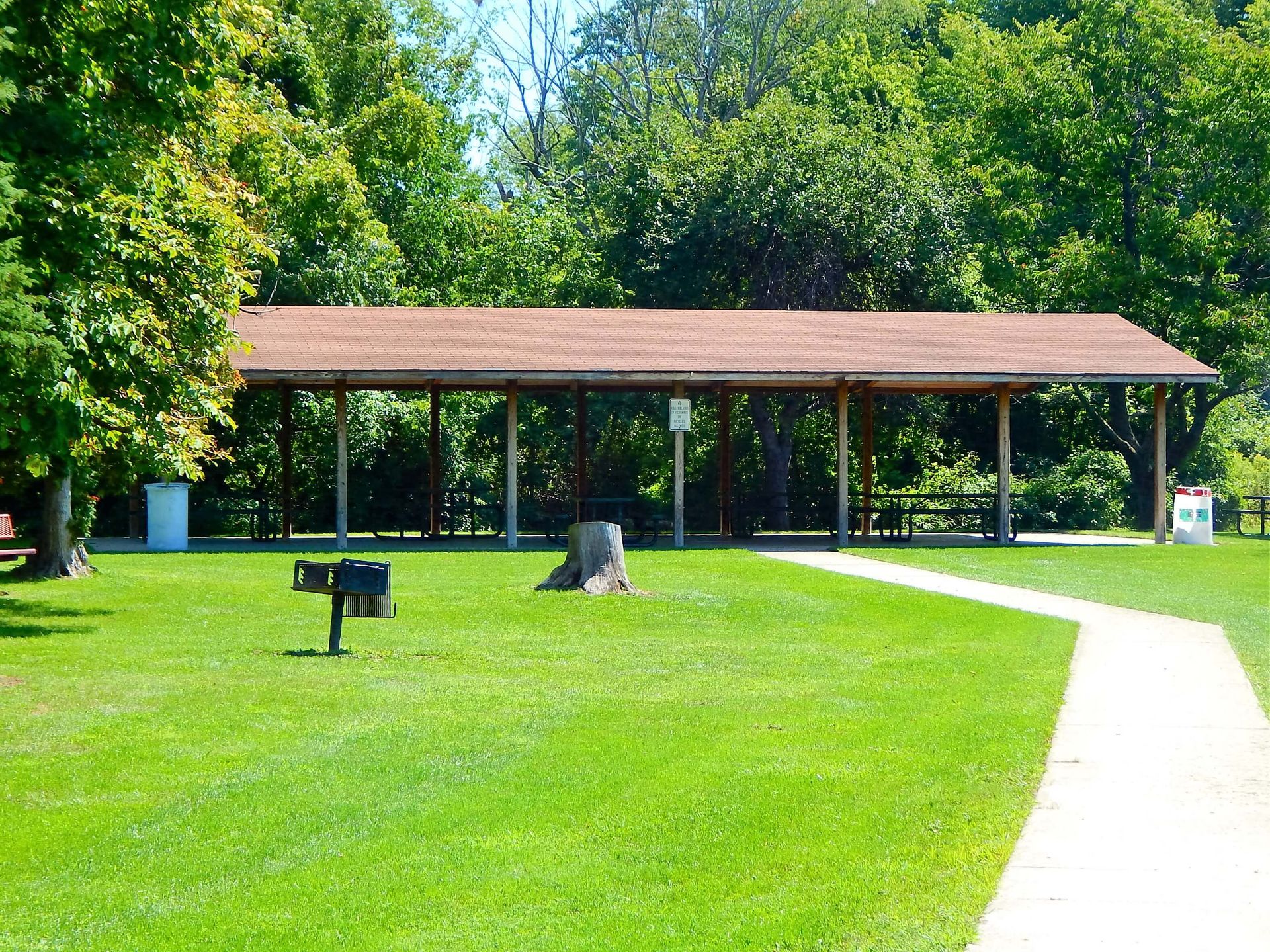 A picnic shelter in the middle of a park.