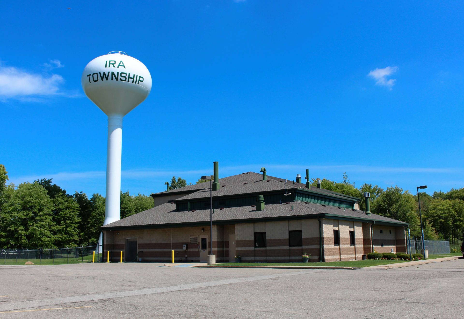 A white water tower with Ira Township written on it.