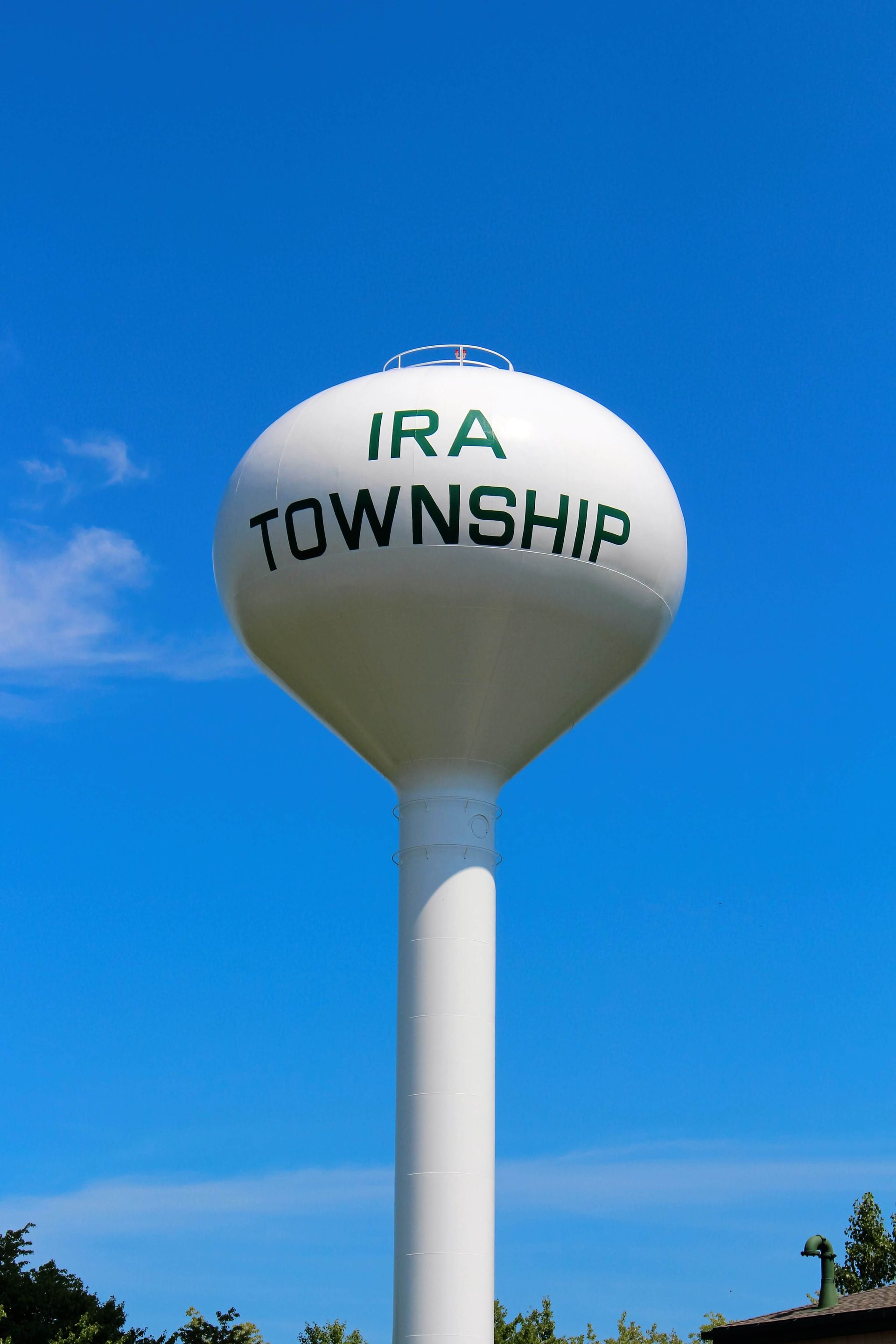 Ira Township water tower against a blue sky.