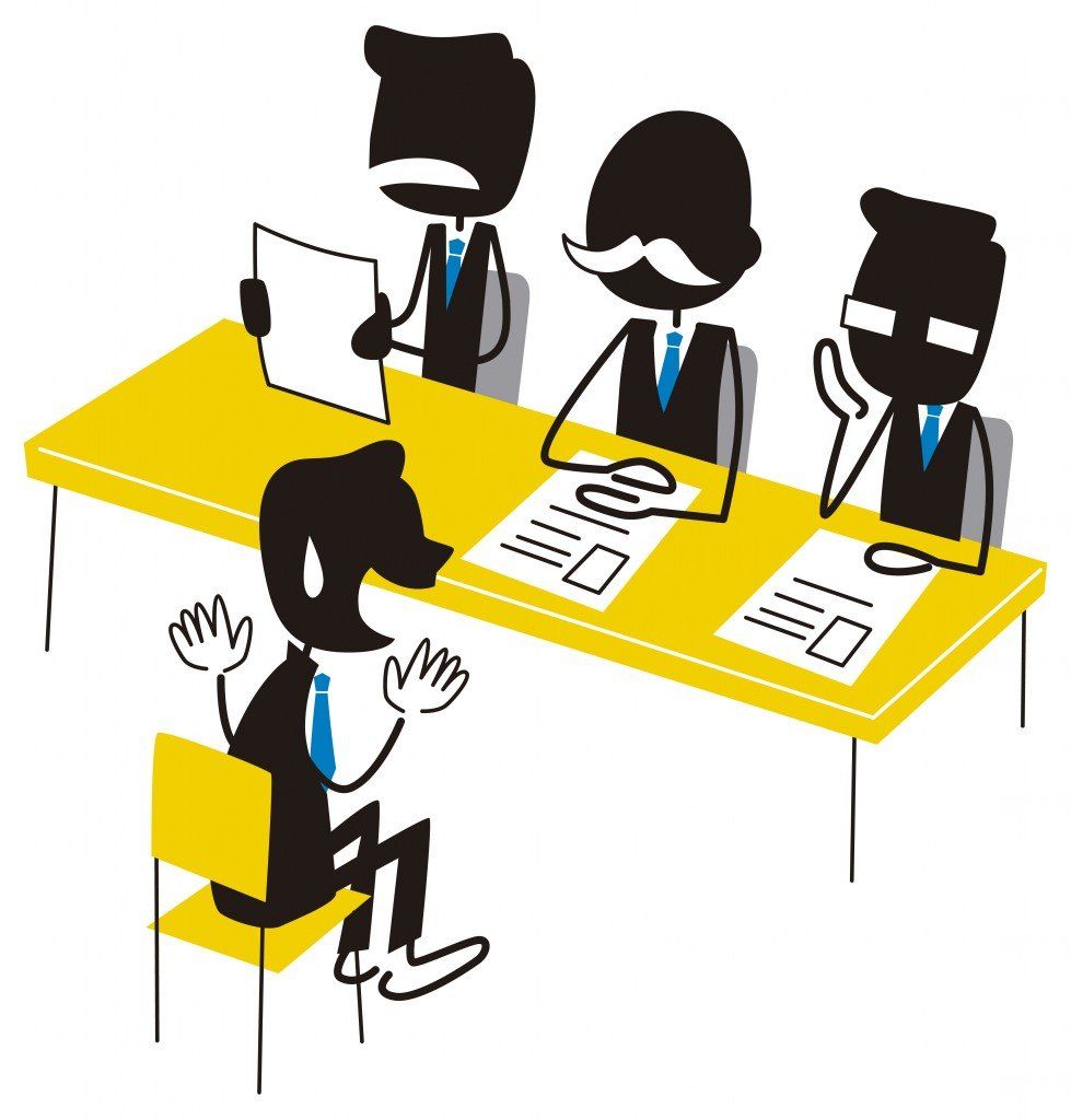 group of people are sitting around a table with laptops