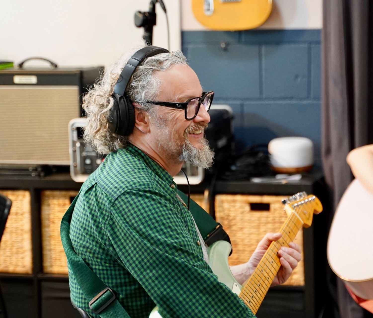 A man is smiling in his guitar lesson